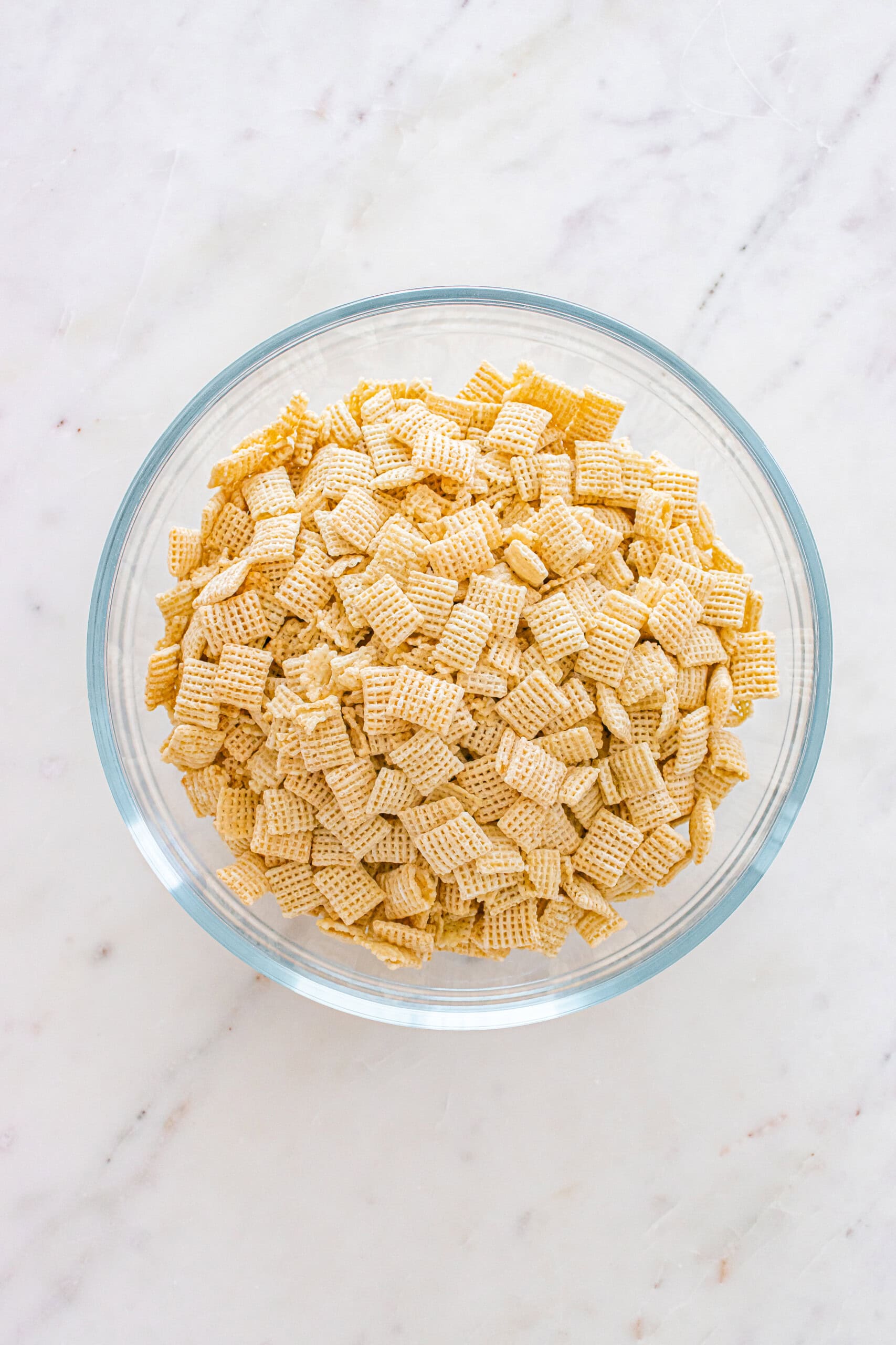 Chex cereal in a glass bowl.