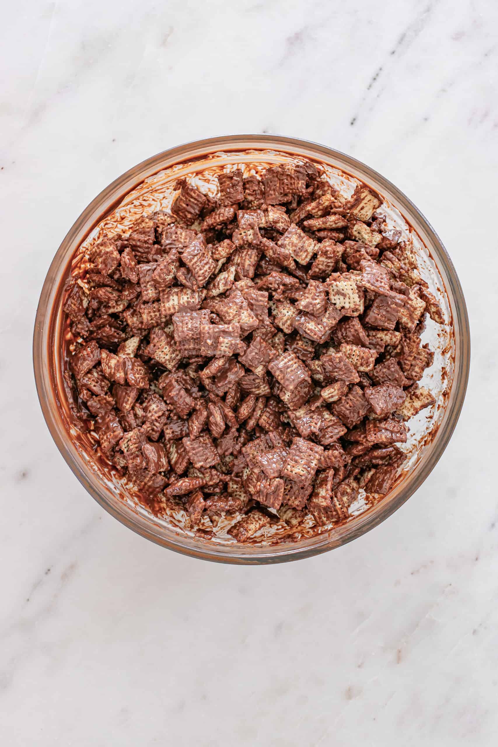 Chex cereal coated in melted chocolate mixture for puppy chow.