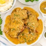 Delicious pork chopsin a rich, creamy sauce with herbs, served with mashed potatoes and broccol.