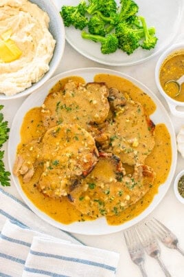 Delicious pork chopsin a rich, creamy sauce with herbs, served with mashed potatoes and broccol.