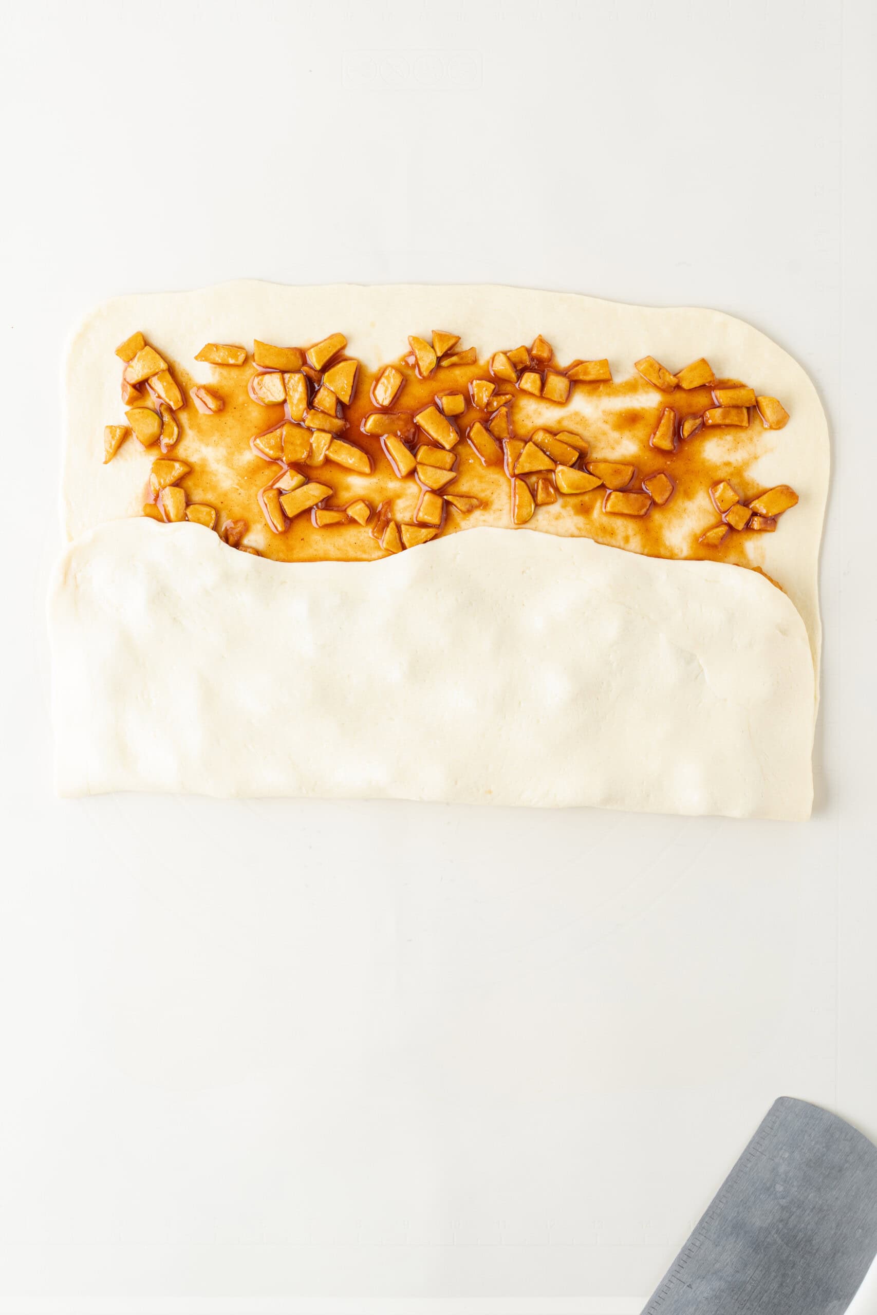 Dough folded over the cinnamon apple filling.