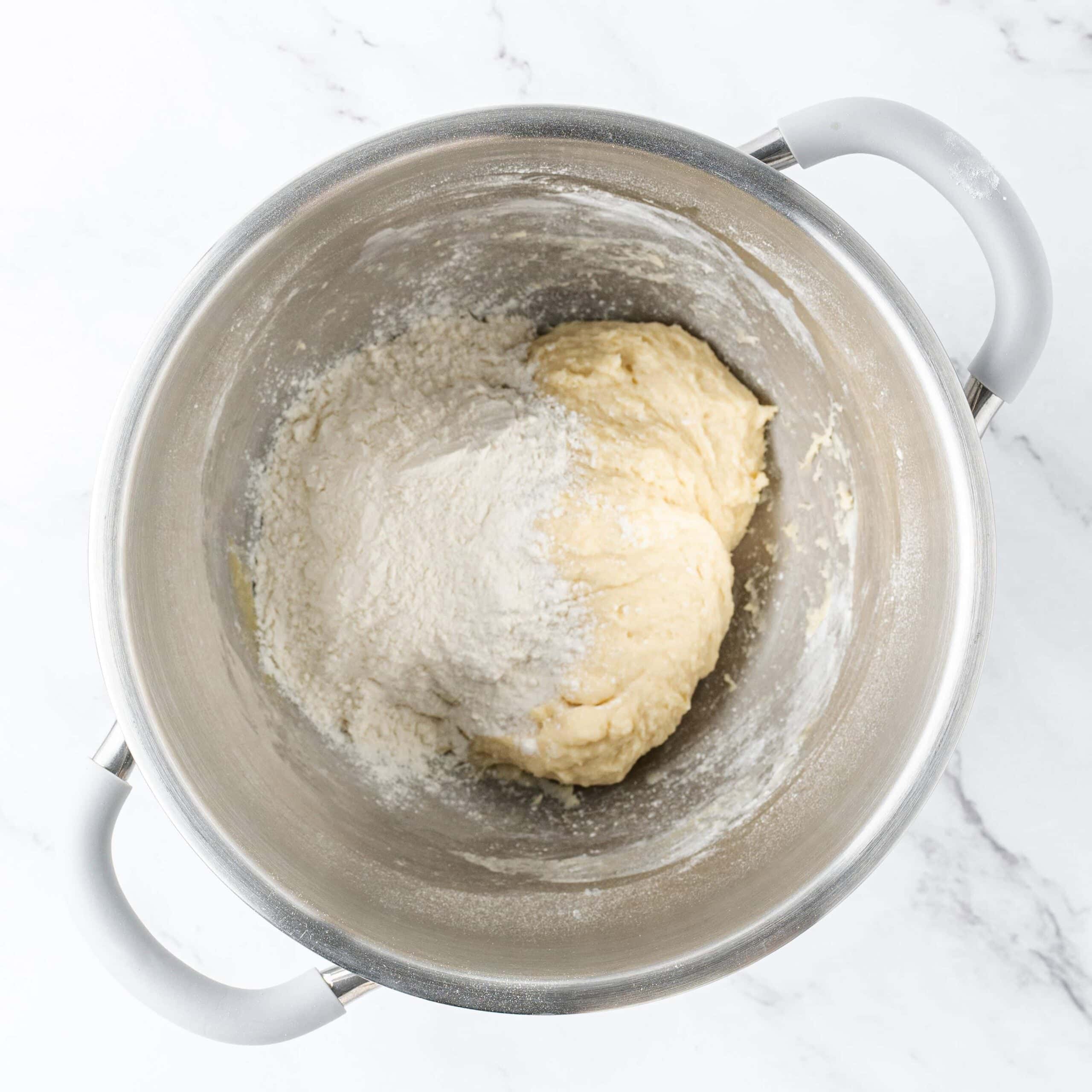 dough with remaining flour added in a mixing bowl.