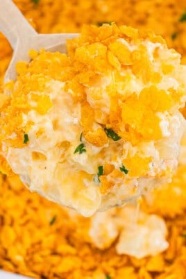 Funeral potatoes topped with crispy cornflake crust and creamy cheesy potato filling