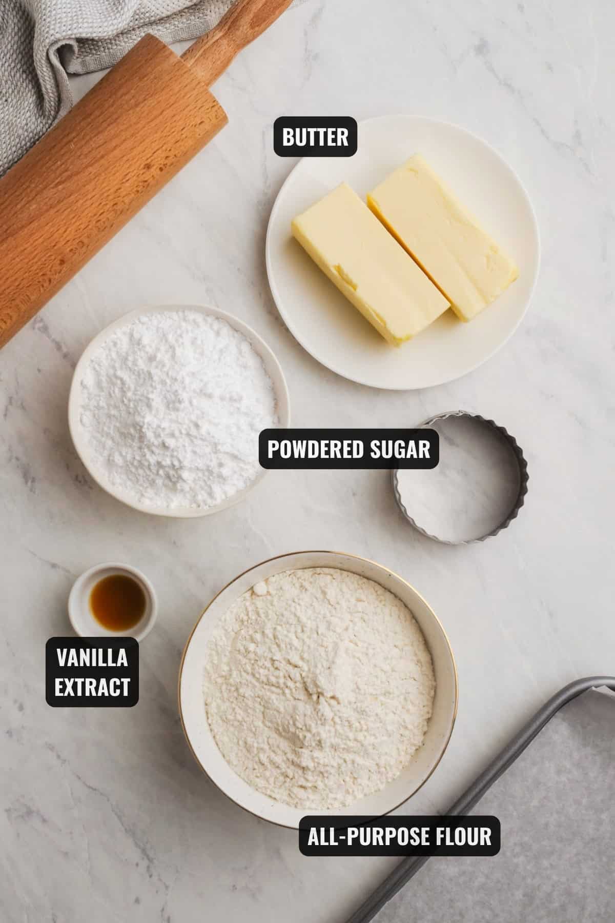 ingredients for shortbread cookies recipe including butter, powdered sugar, all-purpose flour, and vanilla extract