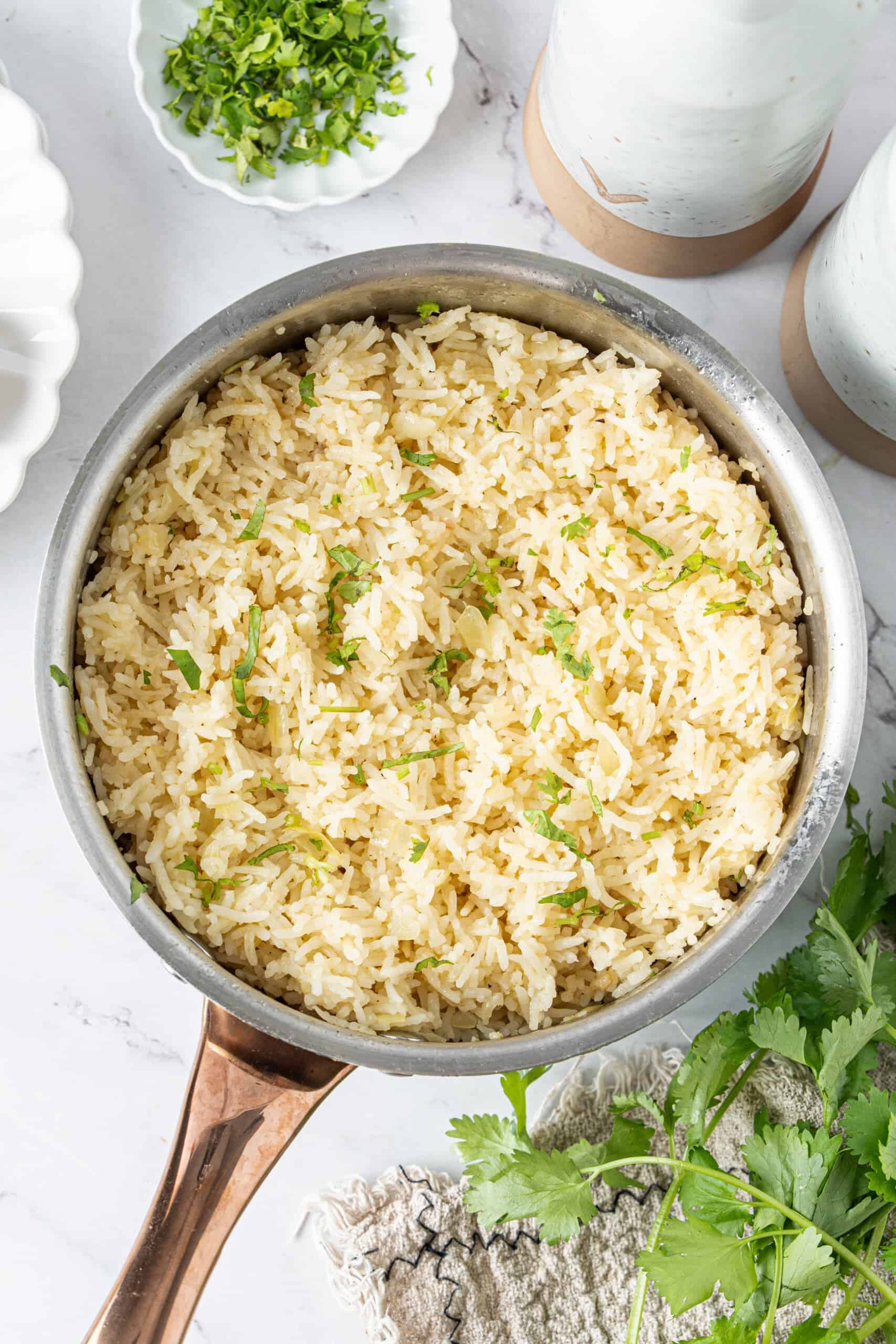 Fluffy butter with onions and fresh parsley in a saucepan.