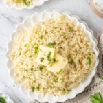 Bowl of fluffy butter rice topped with butter and fresh parsley