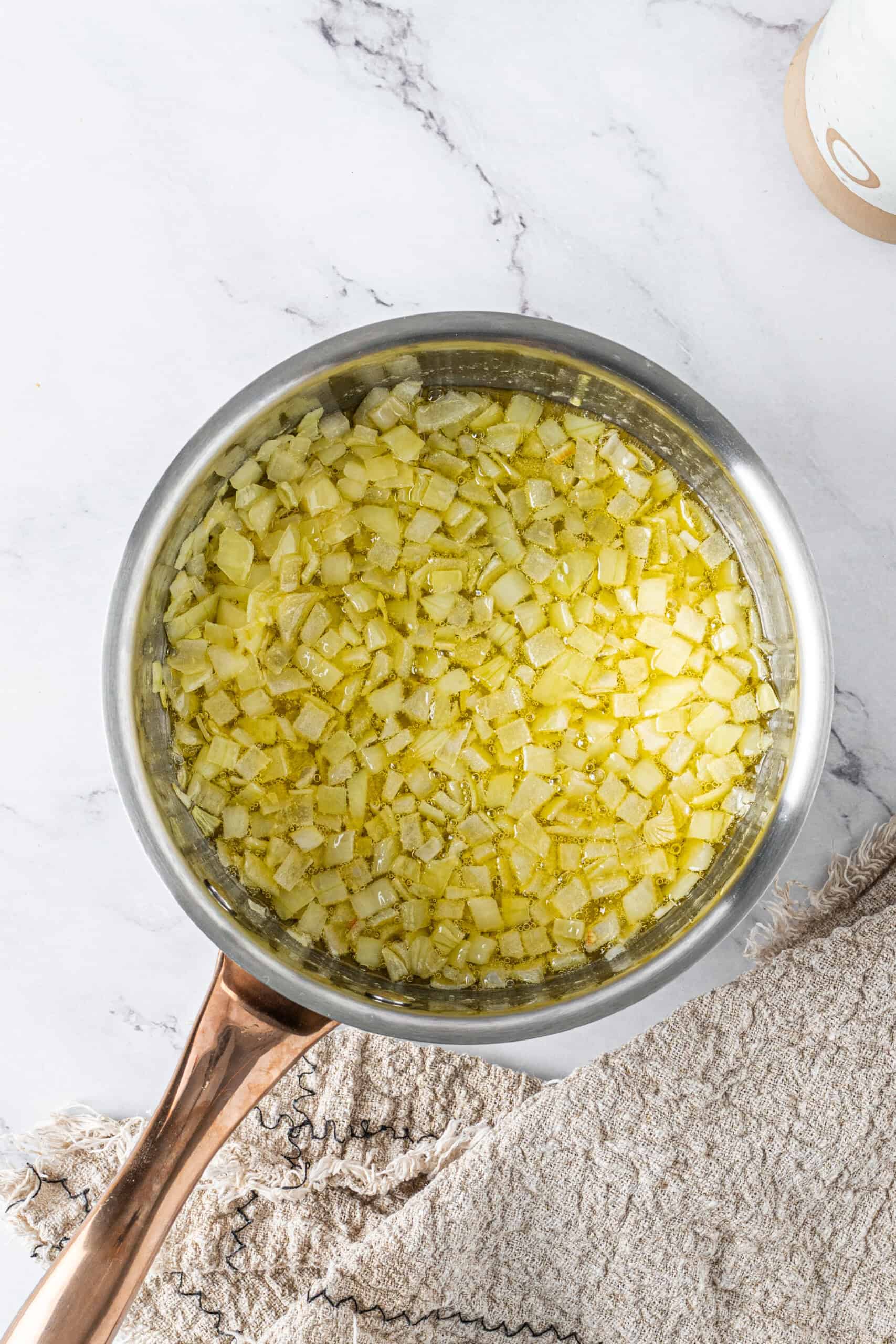 Diced onions cooking in butter in a saucepan