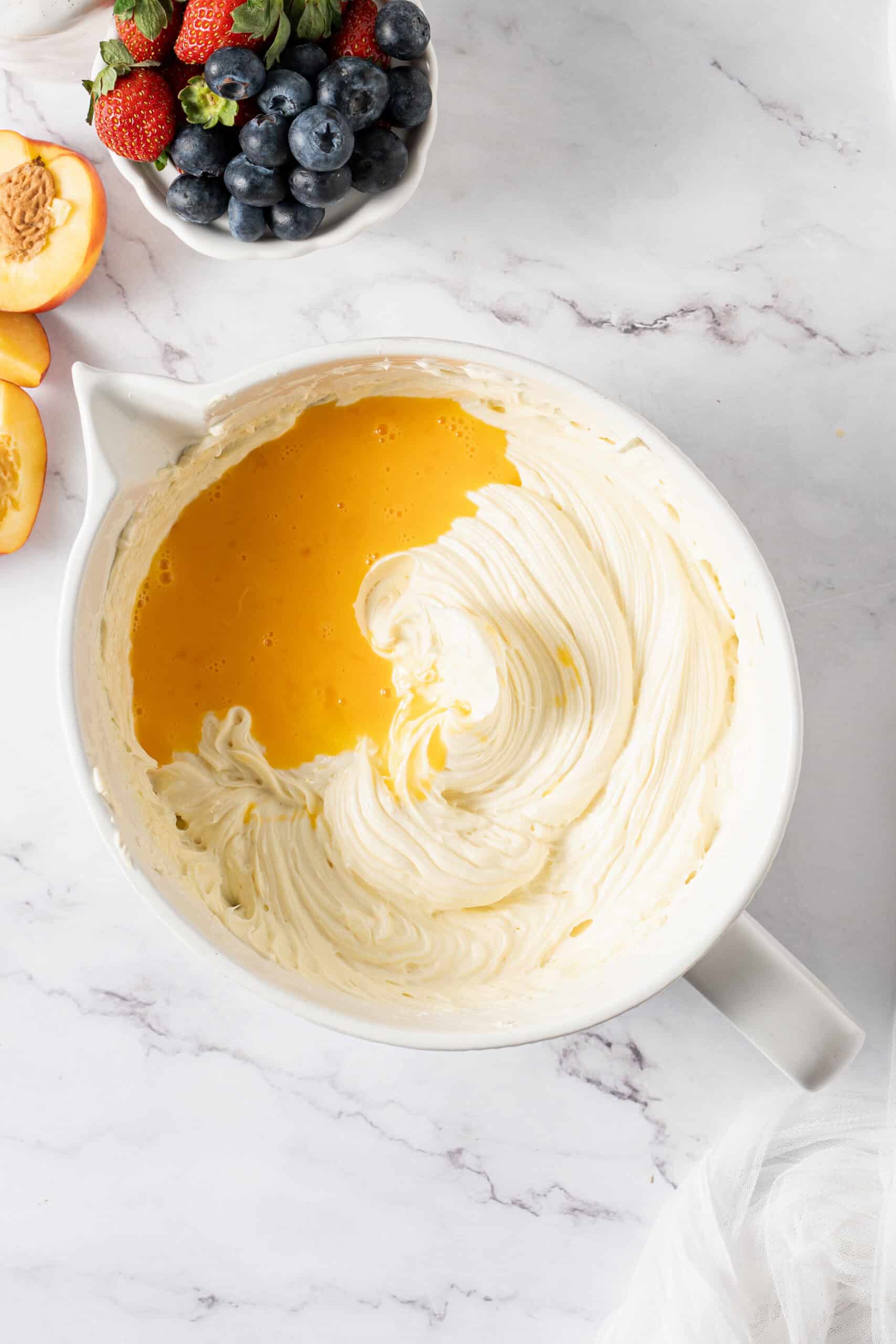 Whisked eggs added to the whipped cream cheese mixture
