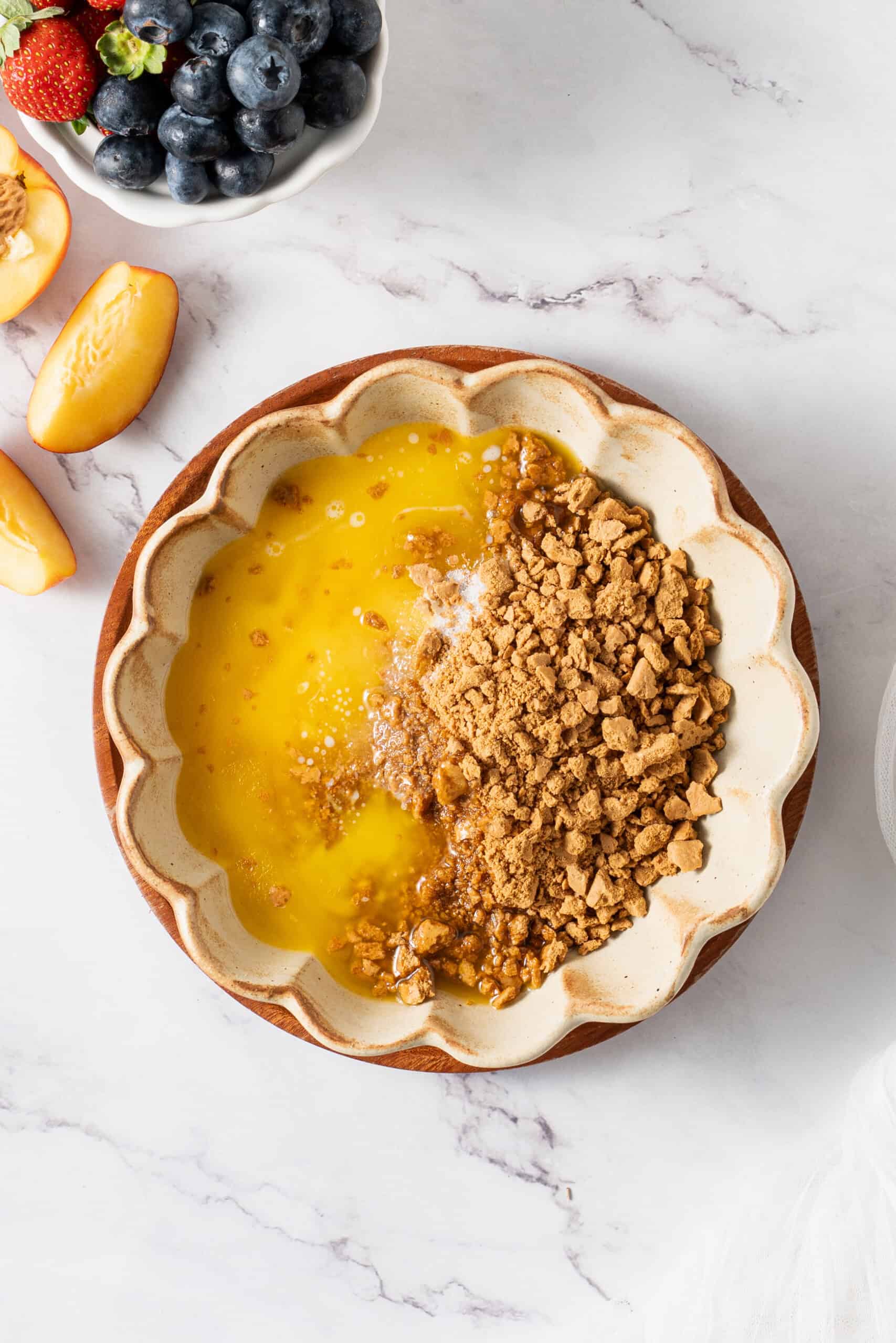 Graham cracker crumbs, melted butter, and sugar in a bowl