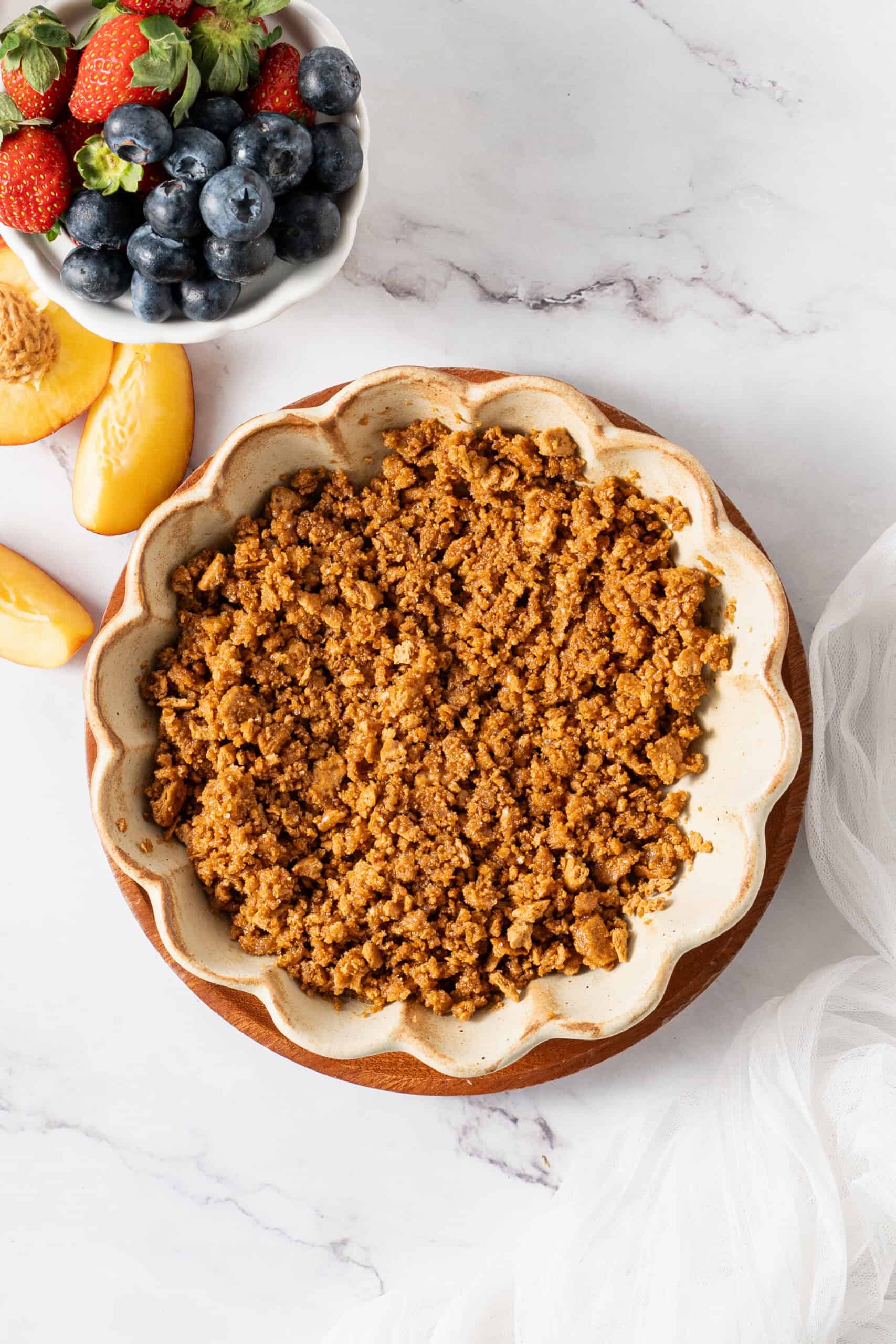 Mixed graham cracker crust in a mixing bowl