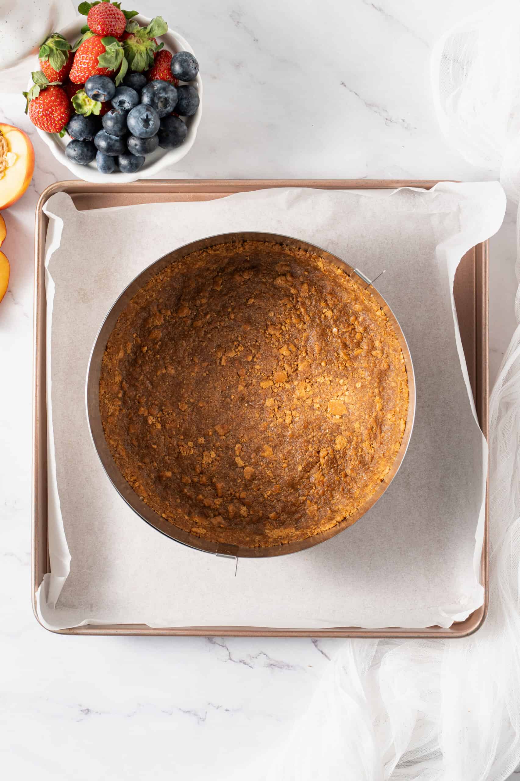 Baked graham cracker crust in a springform pan