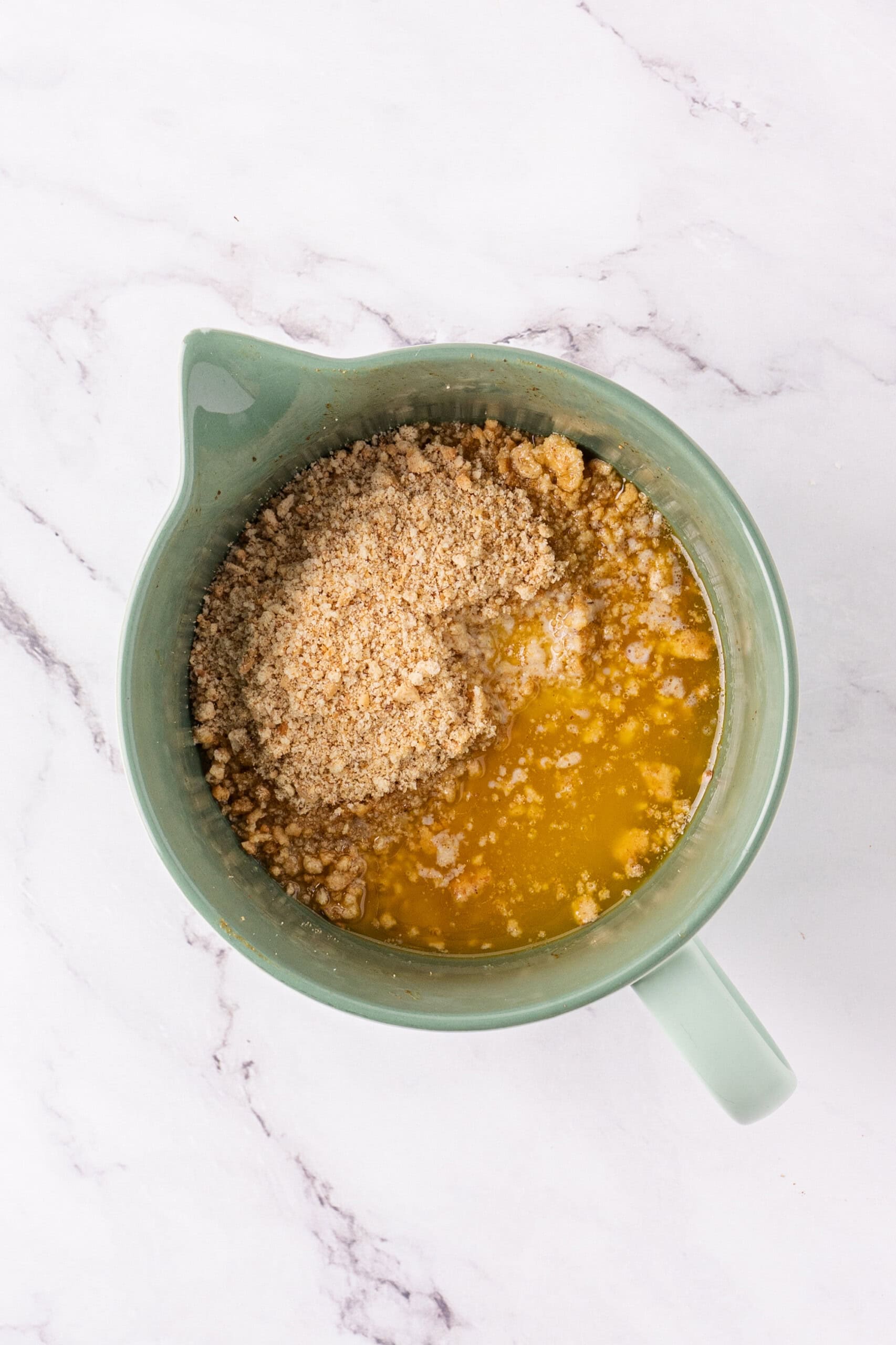 Graham cracker crumbs and melted butter in a mixing bowl