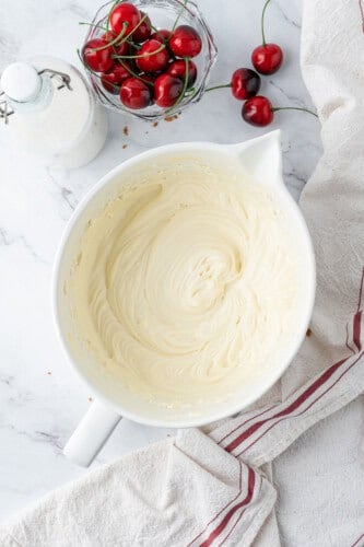Smooth no-bake cheesecake filling mixed until light, creamy, and lump-free in a white mixing bowl.