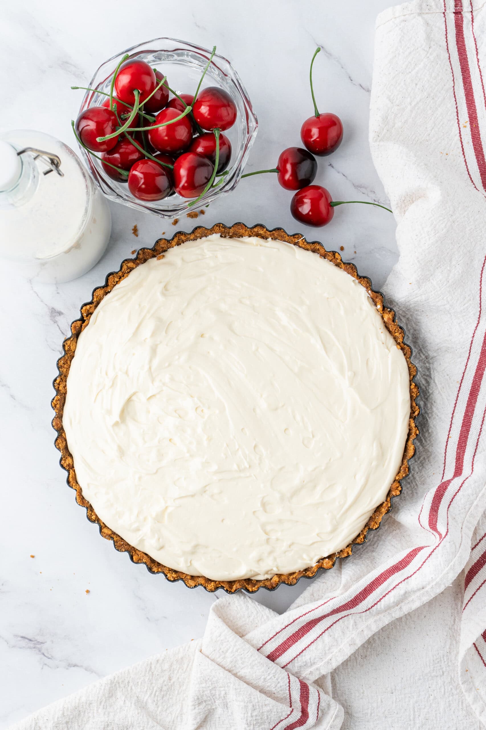 Cheesecake filling spread evenly in a graham cracker crust.