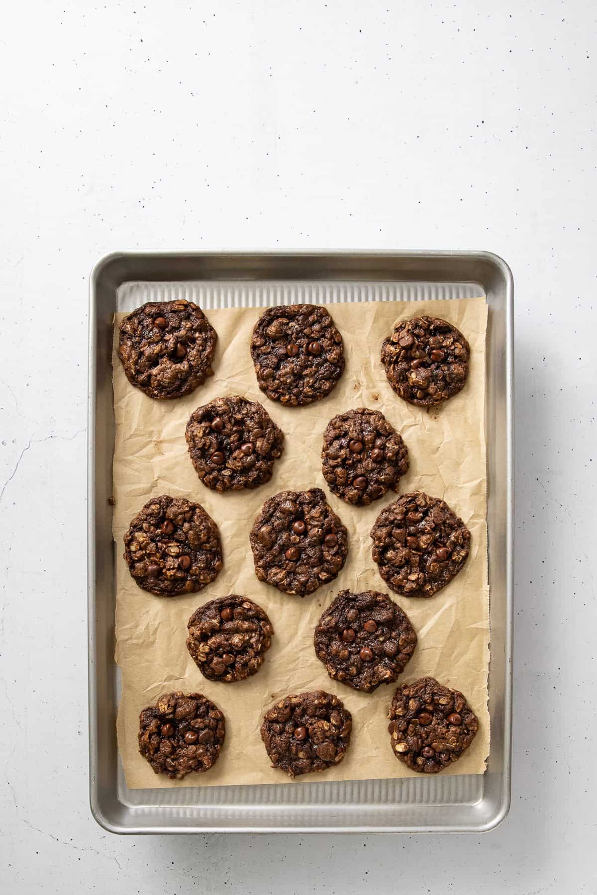Baked cookies with on a parchment-lined baking sheet.