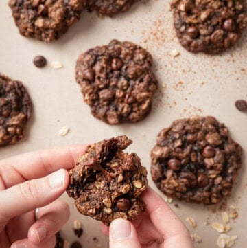 Chocolate oatmeal cookie broken open to show the soft center and melted chocolate chips.