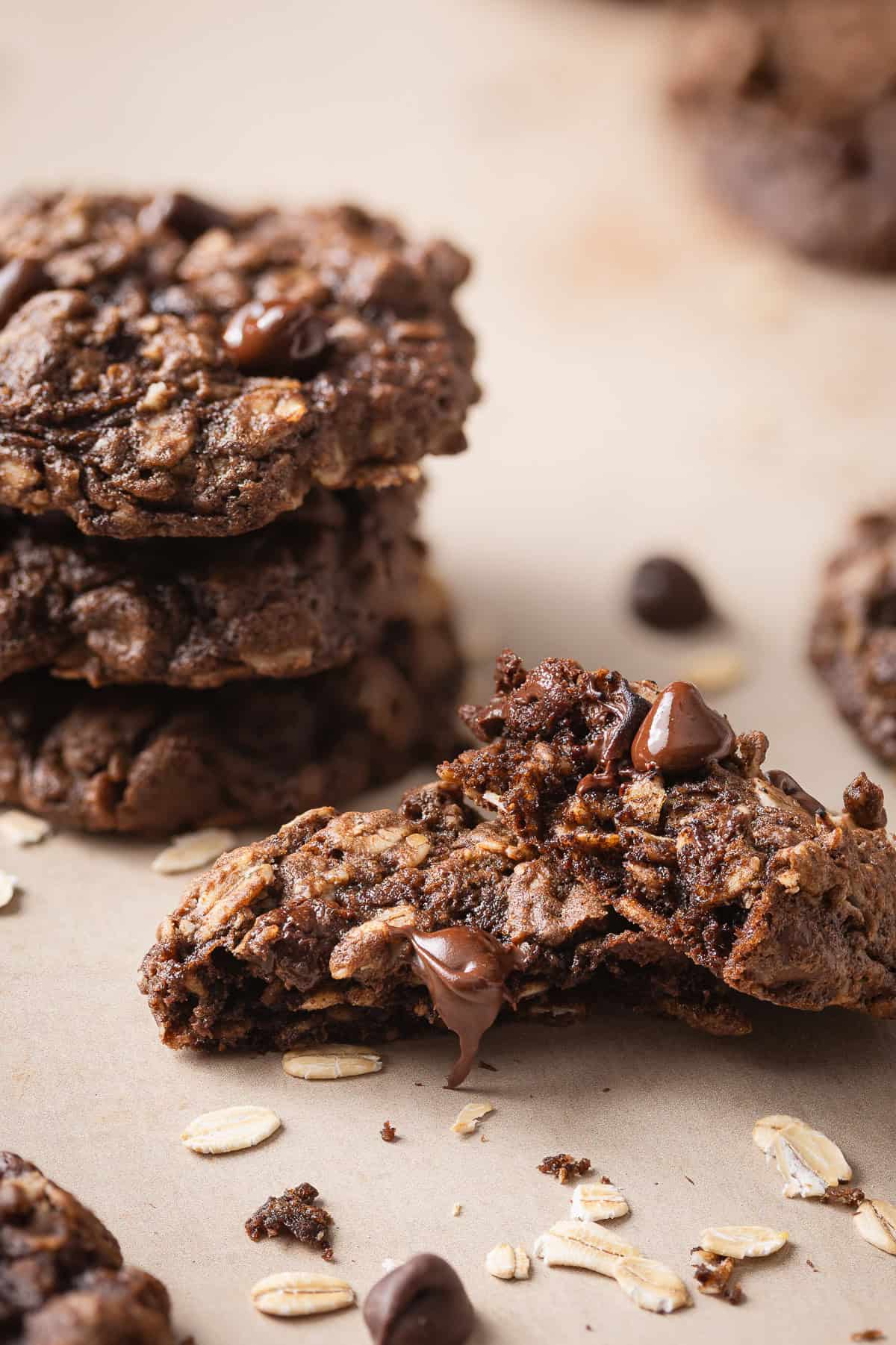 Chocolate oatmeal cookie broken open with gooey melted chocolate chips
