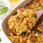 Golden cornbread stuffing served from a casserole dish.