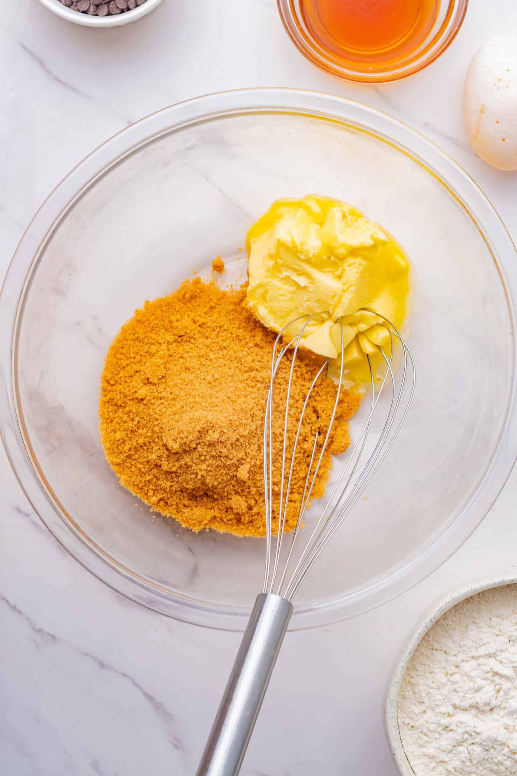 Butter and brown sugar in a mixing bowl with a whisk.