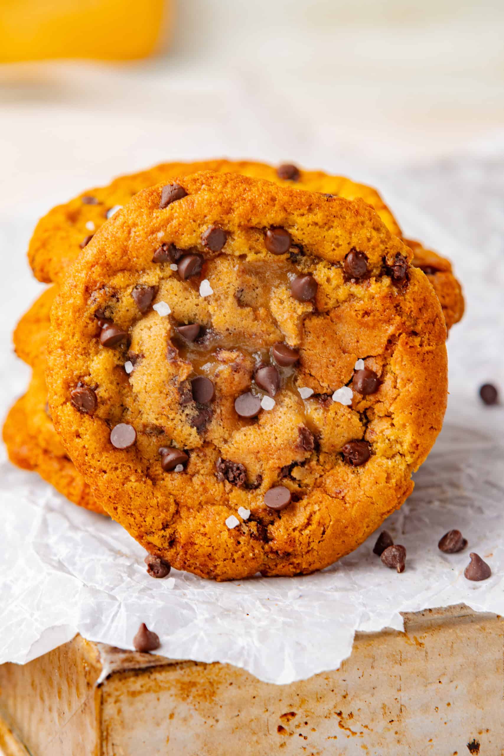 Close-up of a golden maple cookie with a soft center and flaky sea salt