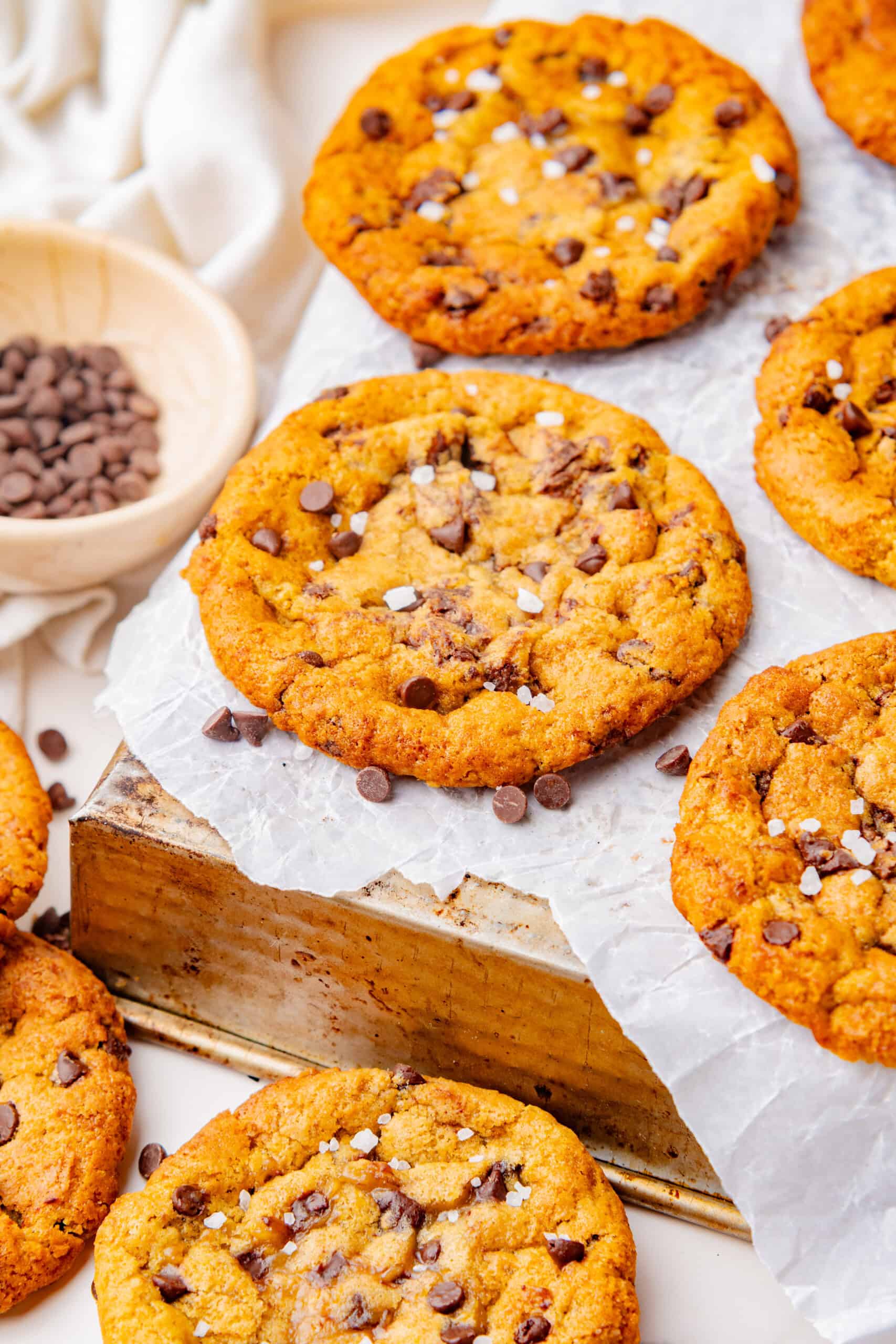 Freshly baked maple cookies arranged on a parchment-lined baking sheet