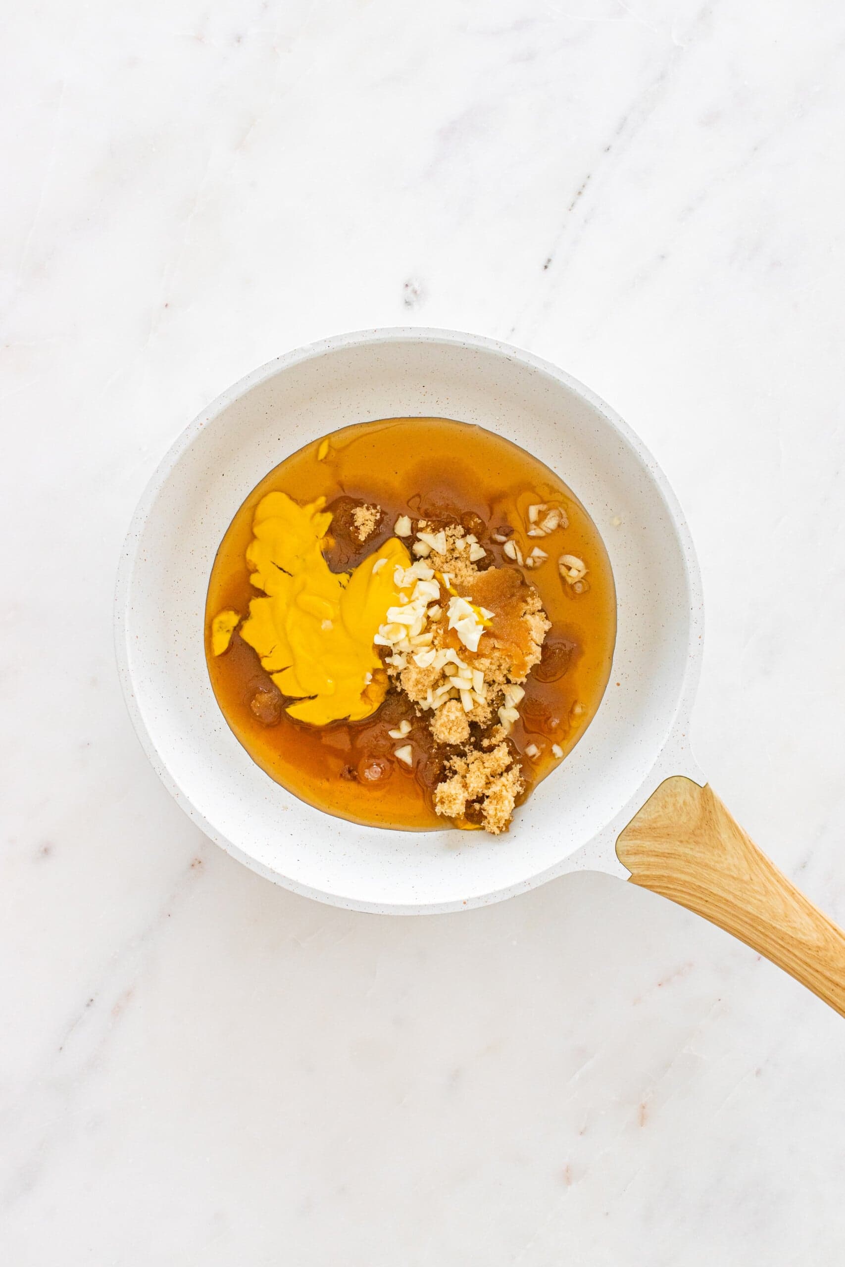 Mustard, brown sugar, maple syrup, and chopped garlic in a saucepan