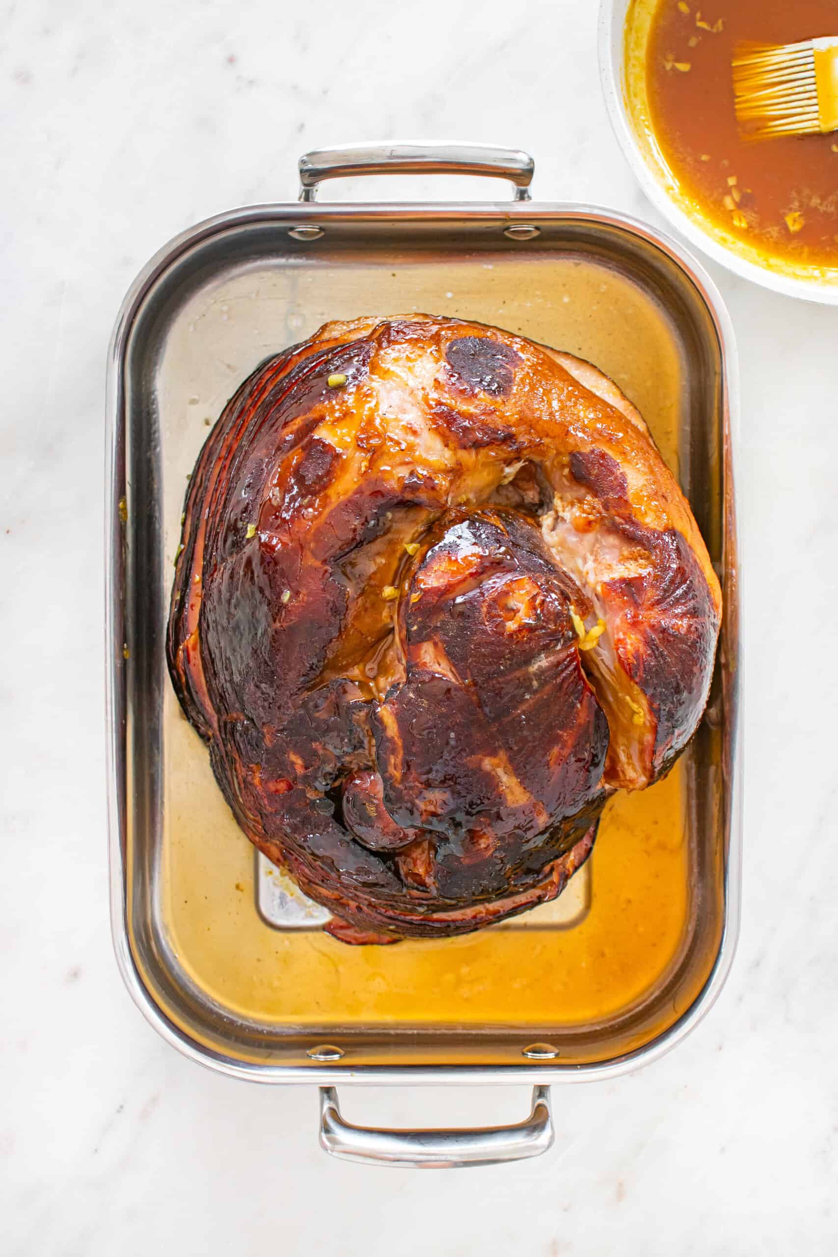 Glazed spiral ham in a roasting pan