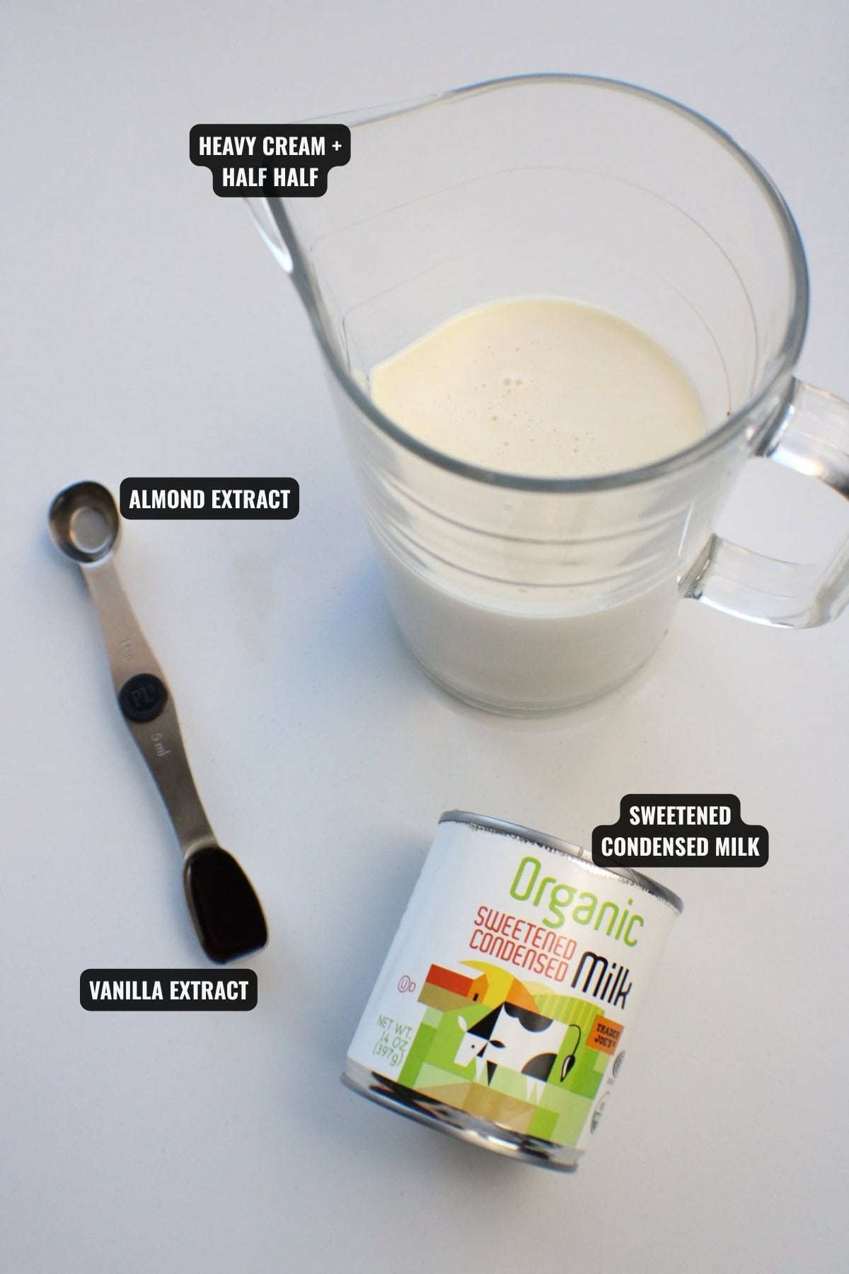ingredients for coffee mate italian sweet cream recipe including heavy cream, half half, sweetened condensed milk, almond extract, and vanilla extract