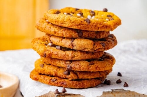 Stack of maple cookies topped with chocolate chips and flaky sea salt