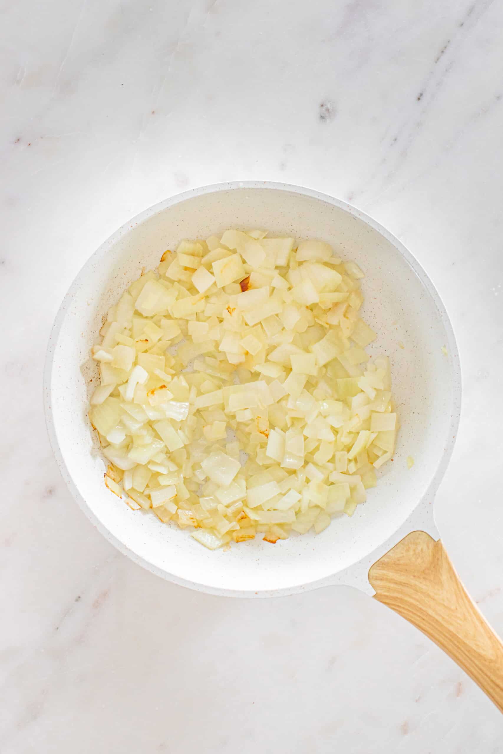 Chopped onions sautéing in a skillet