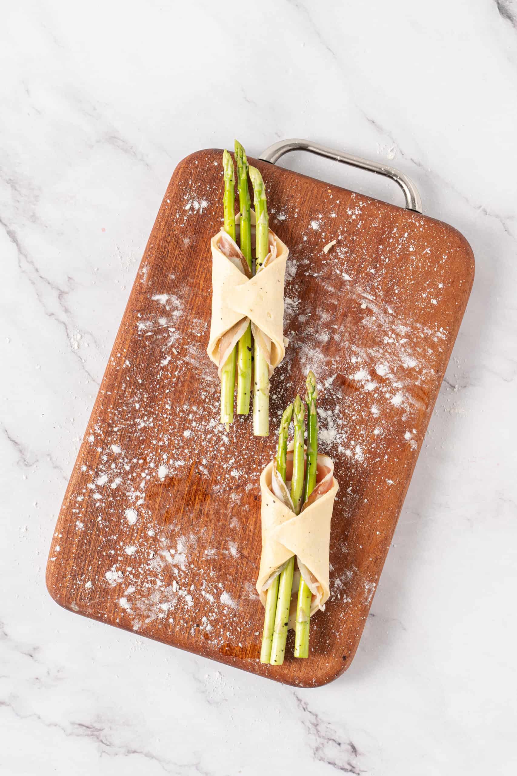 Asparagus and pancetta bundles wrapped in puff pastry and ready to bake.