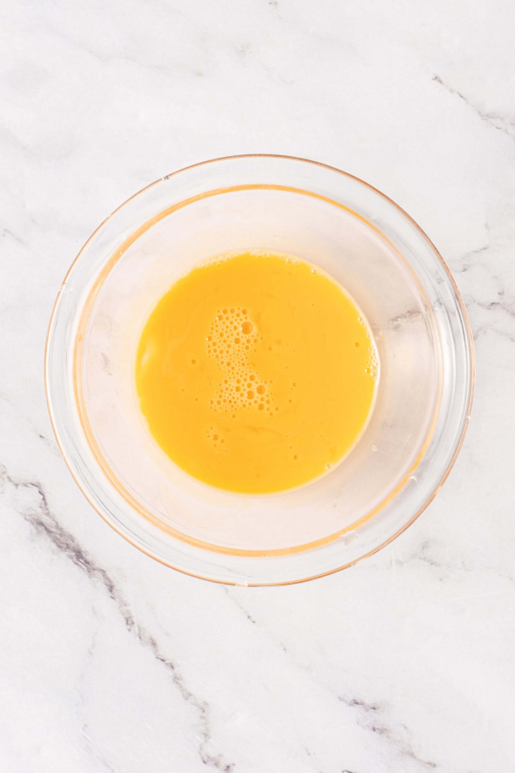 Egg wash in a glass bowl for brushing puff pastry before baking.