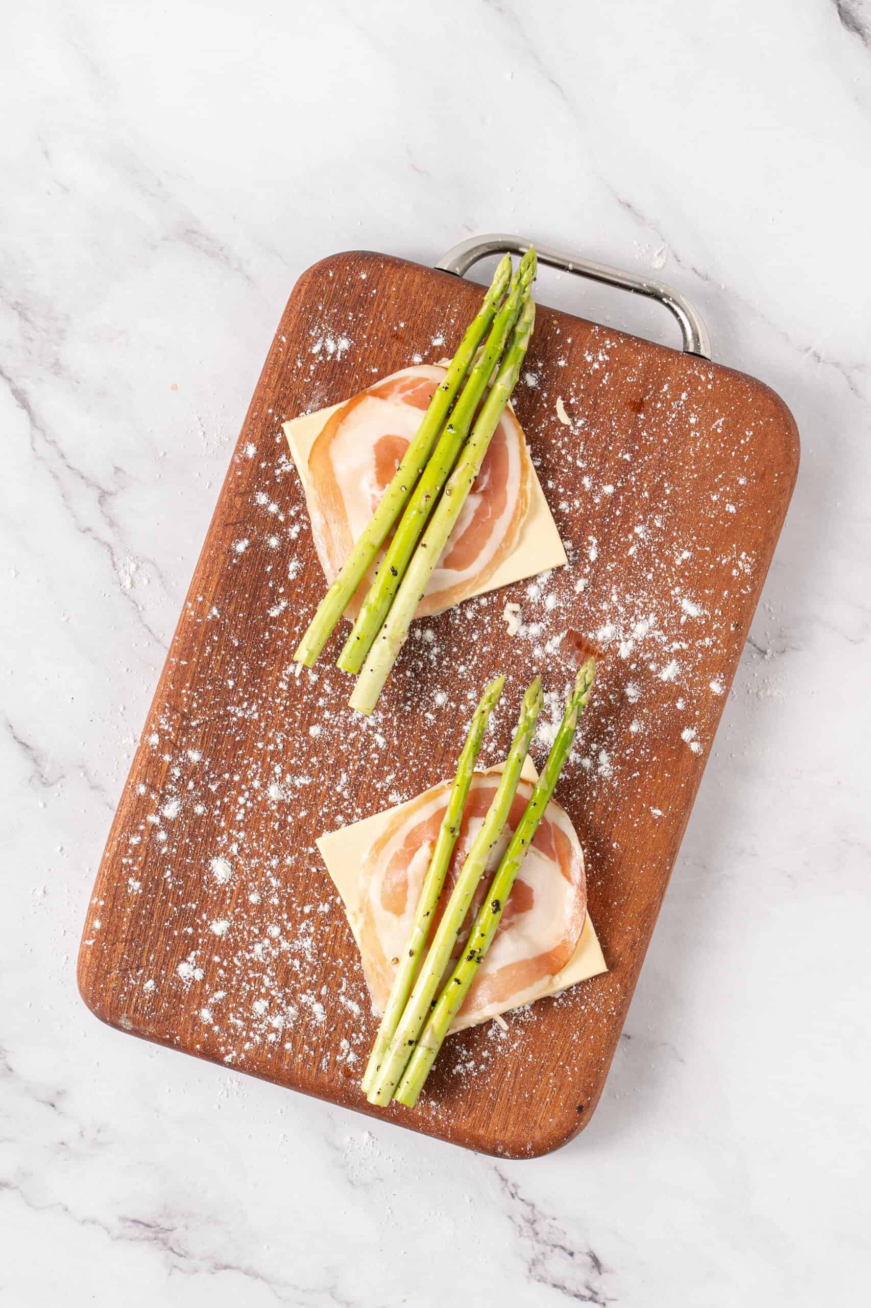 Puff pastry squares topped with pancetta and seasoned asparagus spears.