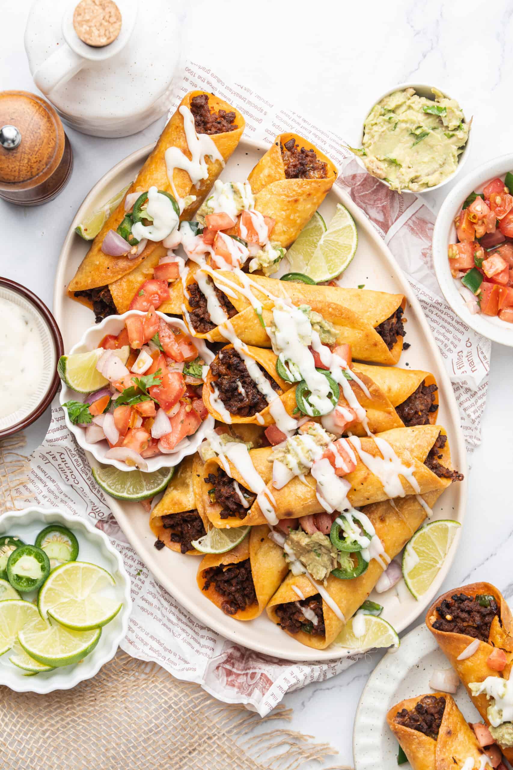 Crispy beef taquitos topped with guacamole, pico de gallo, jalapeños, and crema.