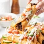 Crispy ground beef taquito topped with pico de gallo, guacamole, and crema.