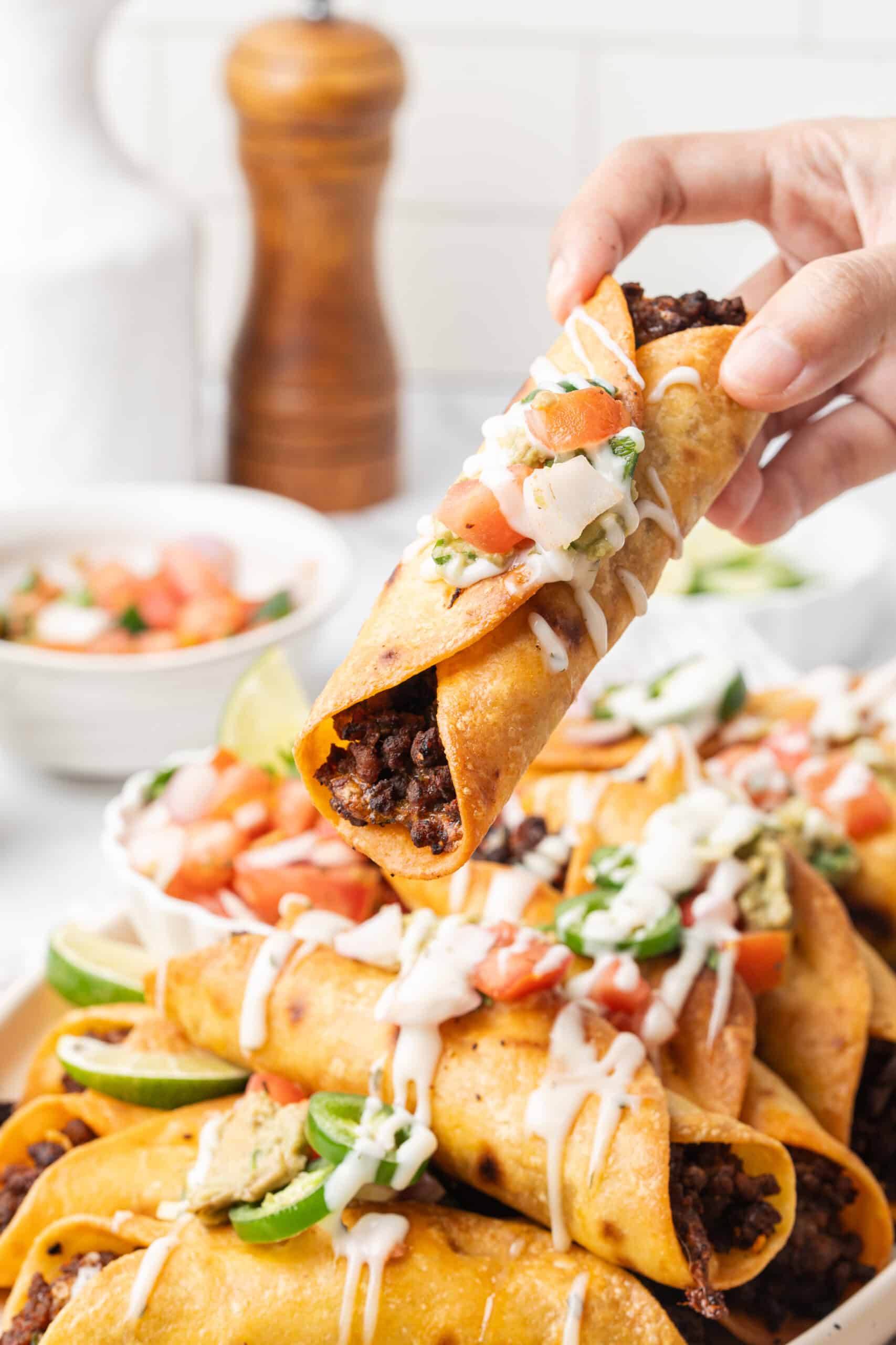 Crispy taquito topped with pico de gallo, guacamole, and crema.