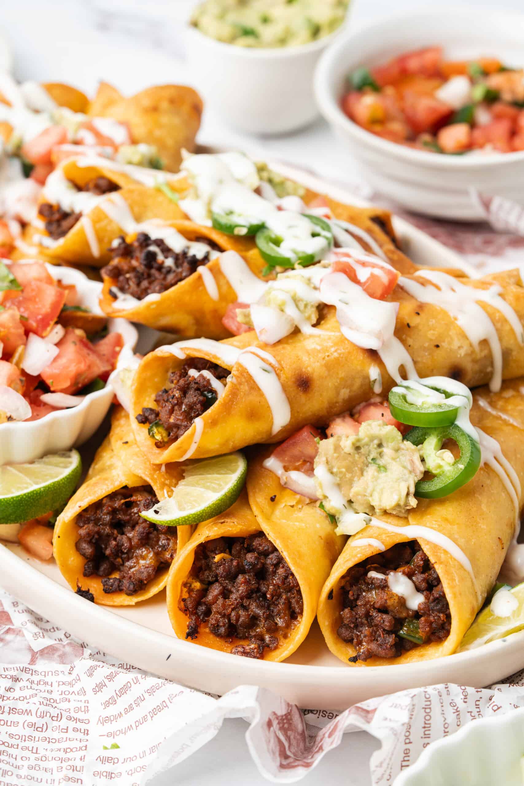 Crispy ground beef taquitos topped with guacamole, pico de gallo, jalapeños, and crema.