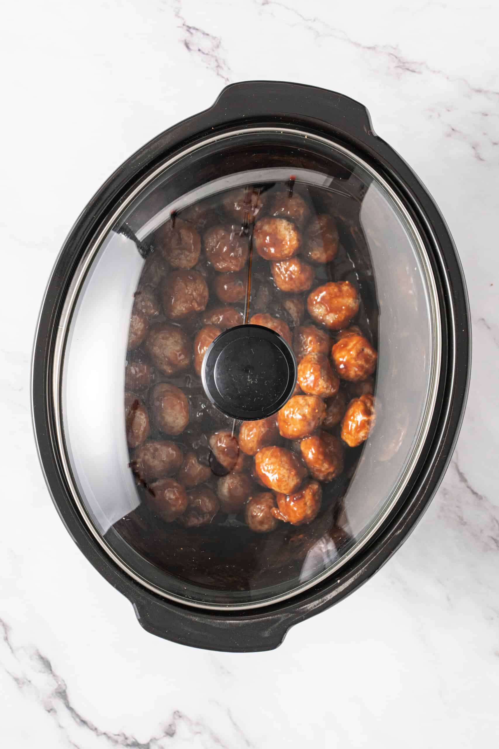 Meatballs in a covered slow cooker.