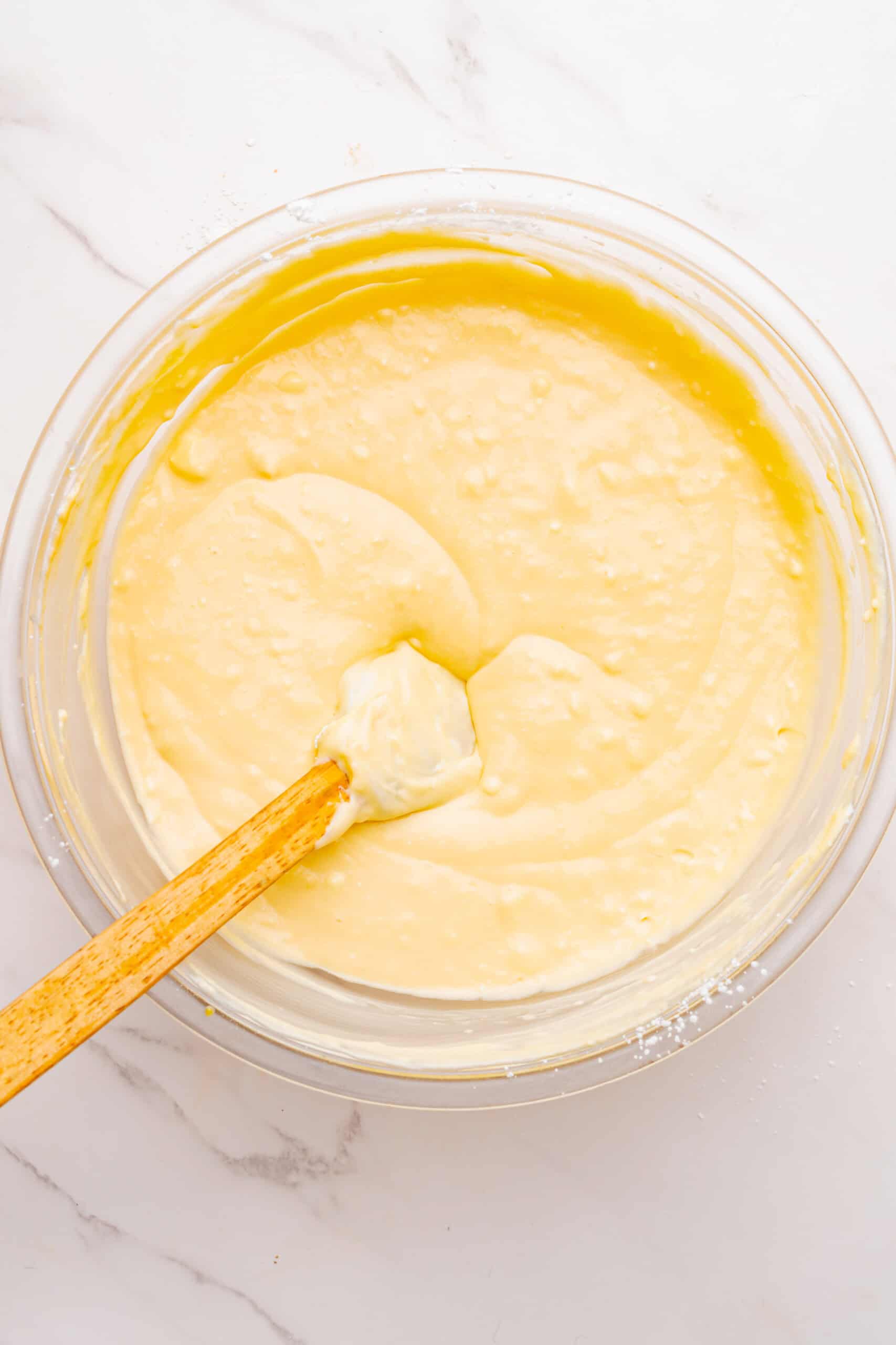 cheesecake filling mixed with cornstarch in a glass bowl.