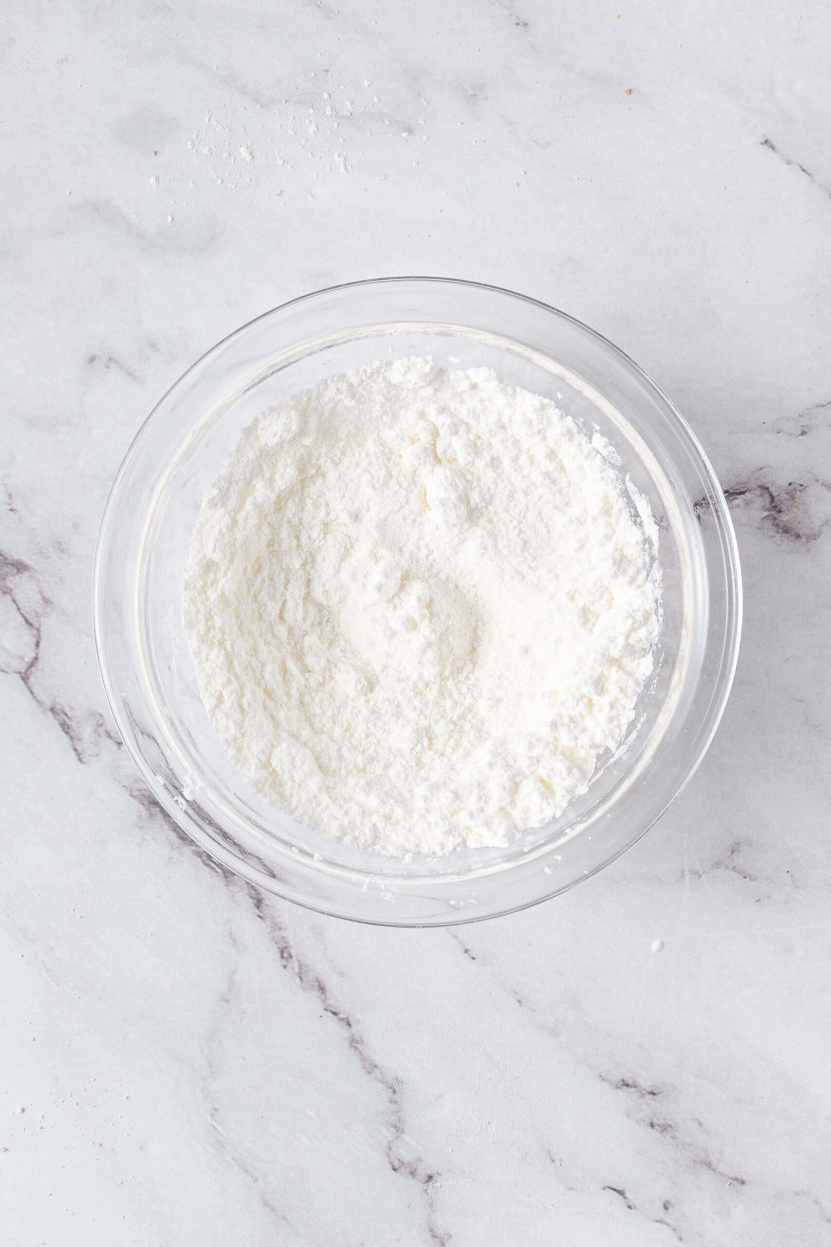 Cornstarch and granulated sugar mixed together in a glass bowl.