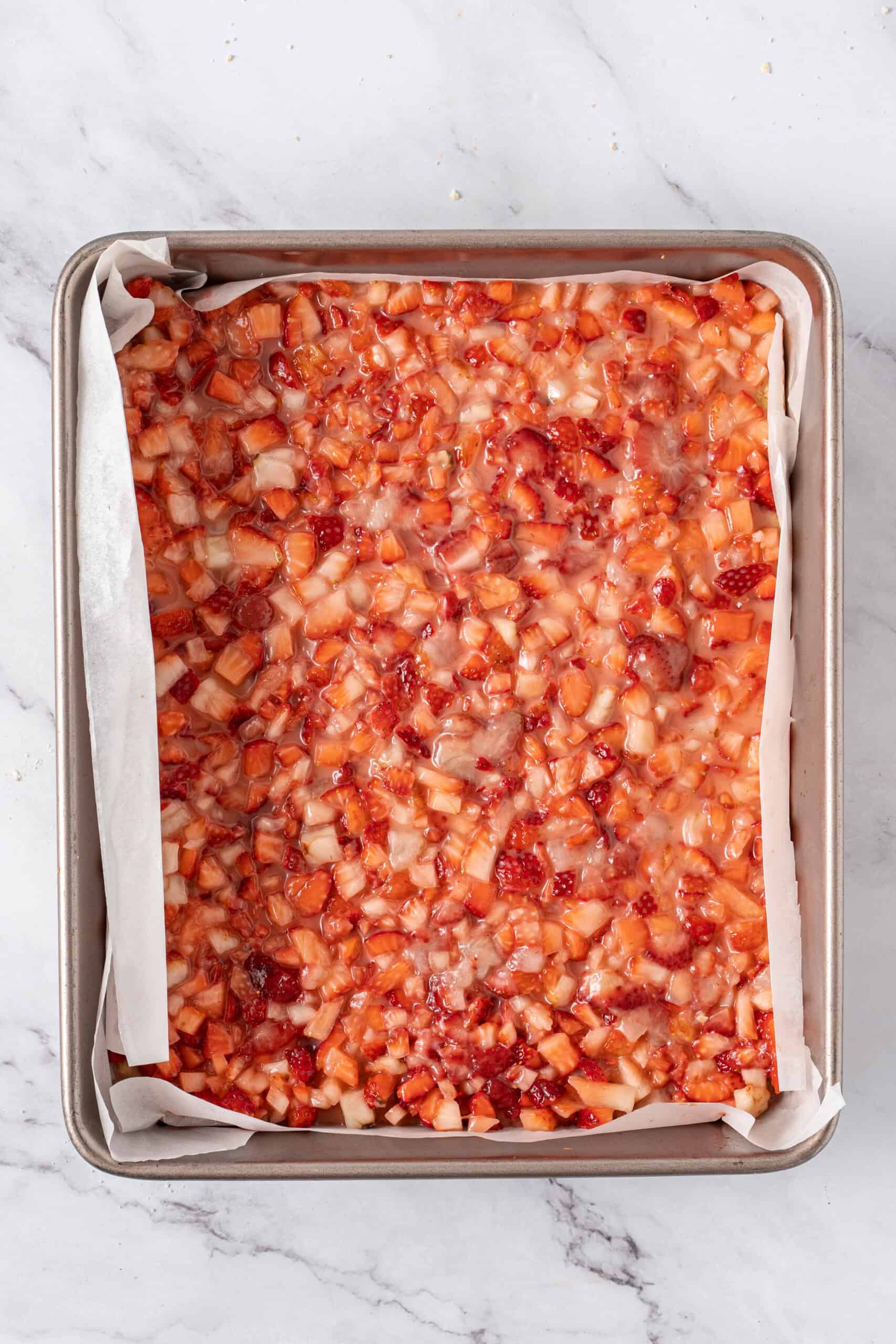 Strawberry filling spread evenly over the baked crust.