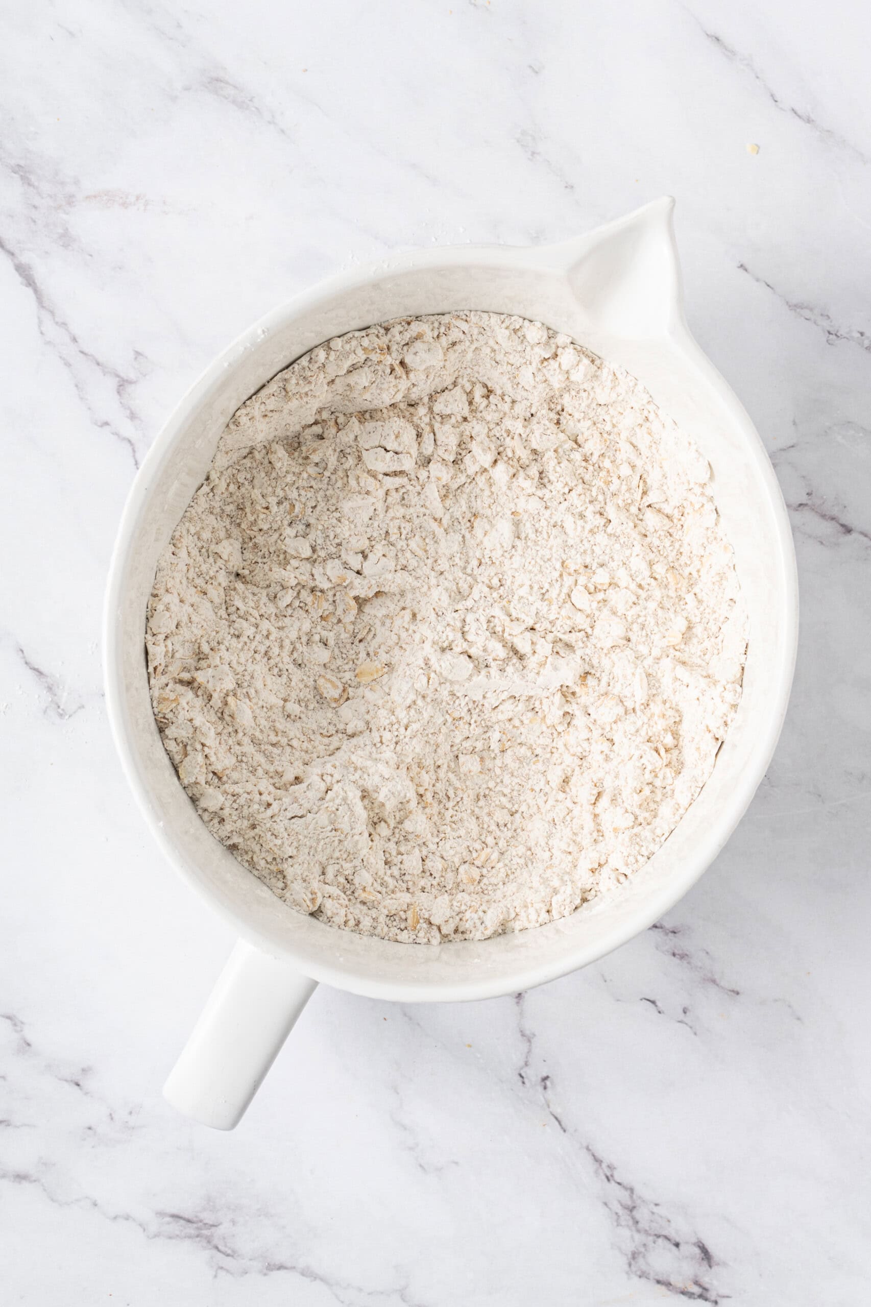 Dry ingredients mixed together in a white mixing bowl.