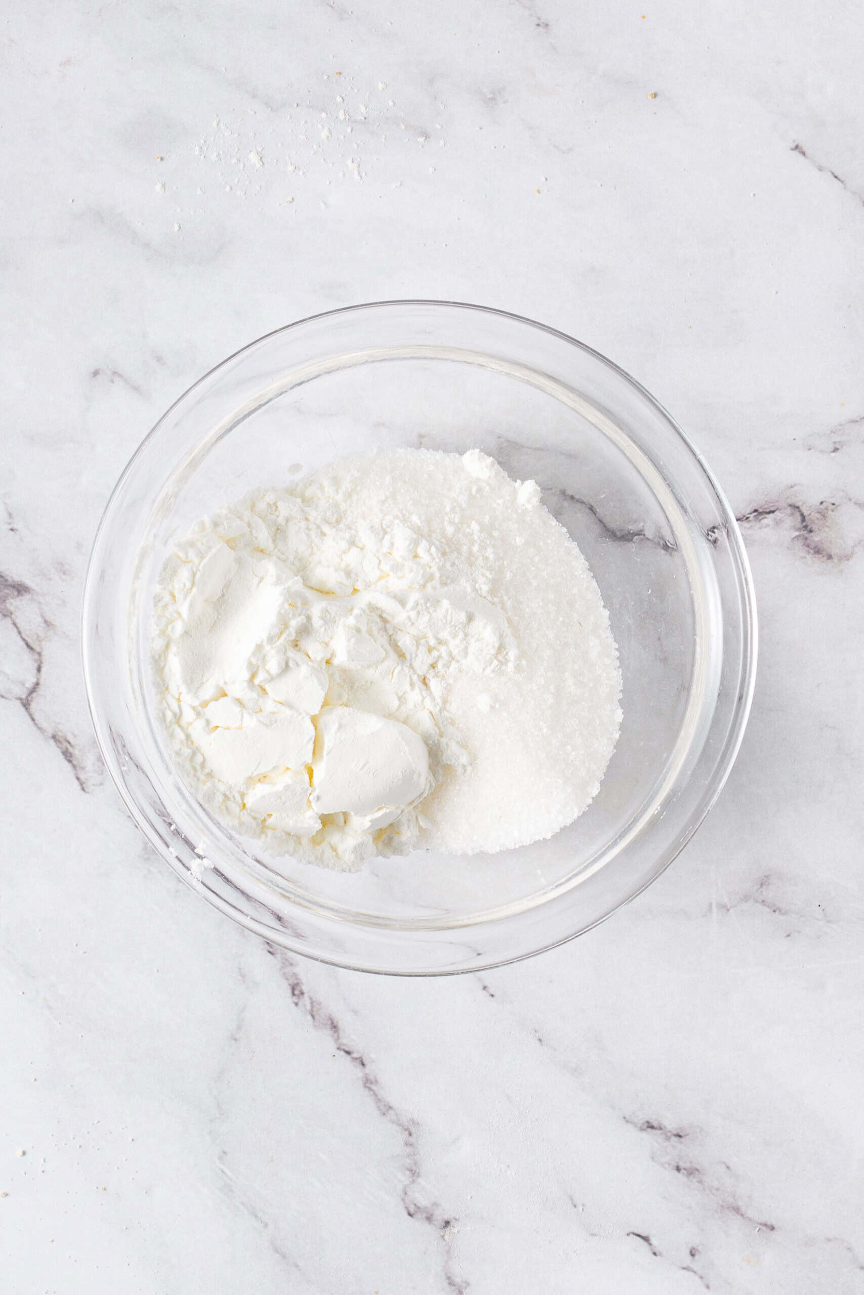 Cornstarch and granulated sugar in a glass mixing bowl.