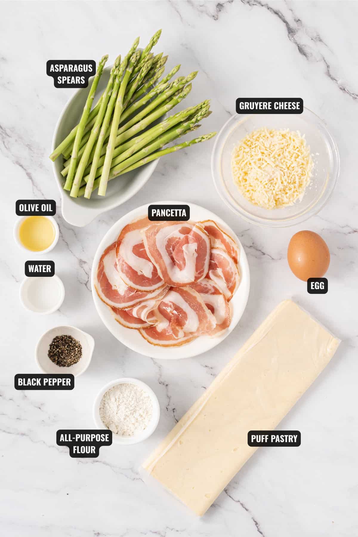 ingredients for asparagus puff pastry bundles recipe including asparagus, gruyere cheese, egg, puff pastry, pancetta, all-purpose flour, black pepper, water, olive oil