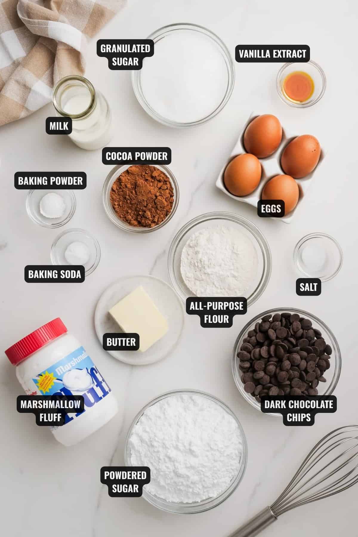 ingredients for chocolate swiss roll recipe including all-purpose flour, cocoa powder, milk, granulated sugar, vanilla extract, eggs, butter, baking powder, baking soda, chocolate chips, powdered sugar, and marshmallow fluff
