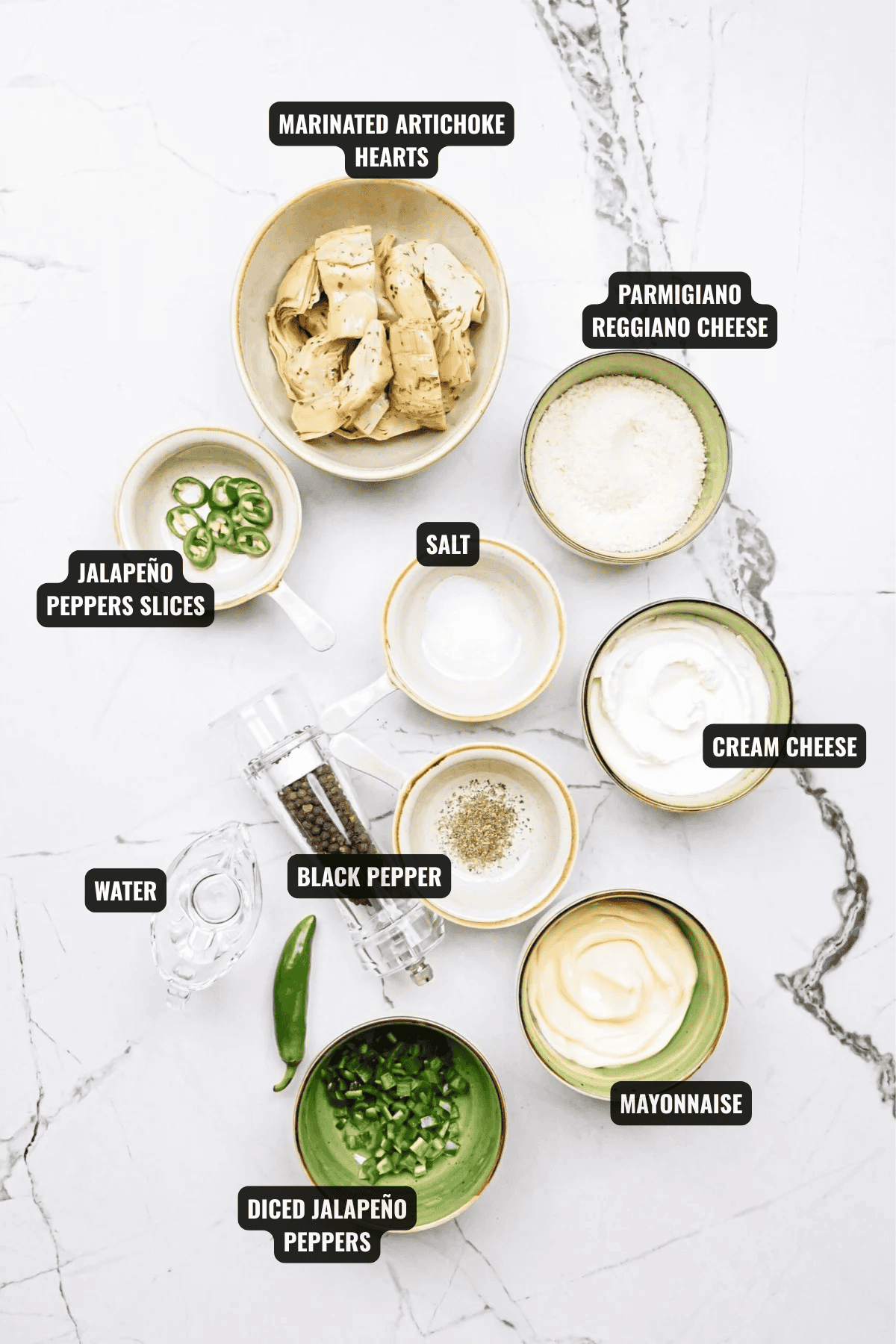 ingredients for jalapeno artichoke dip recipe including artichoke hearts, jalapeno peppers, parmigiano reggiano chees, cream cheese, mayonnaise, black pepper, salt, and water
