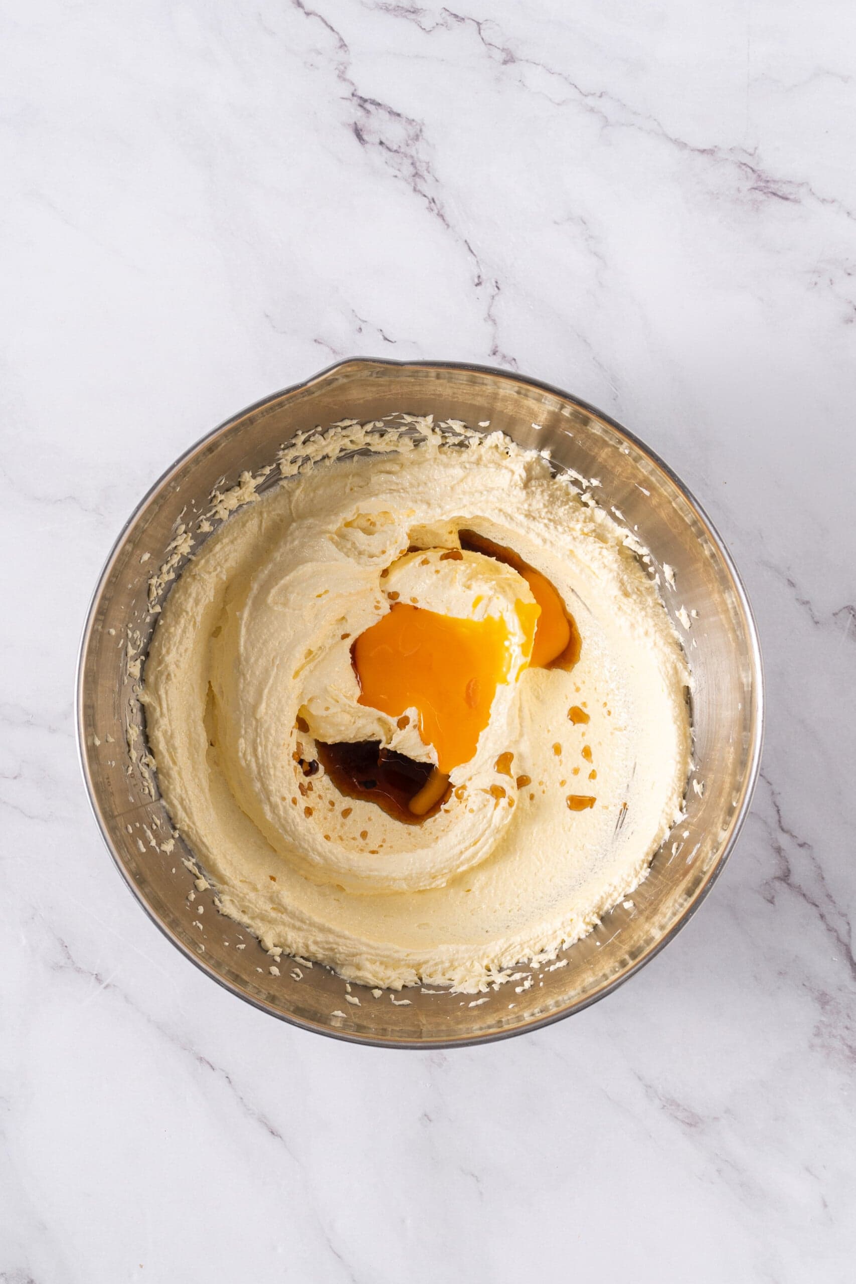 Egg yolk and vanilla extract added to the creamed butter and sugar.