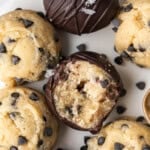 Chocolate chip cookie dough bites, some dipped in chocolate and topped with flaky sea salt.