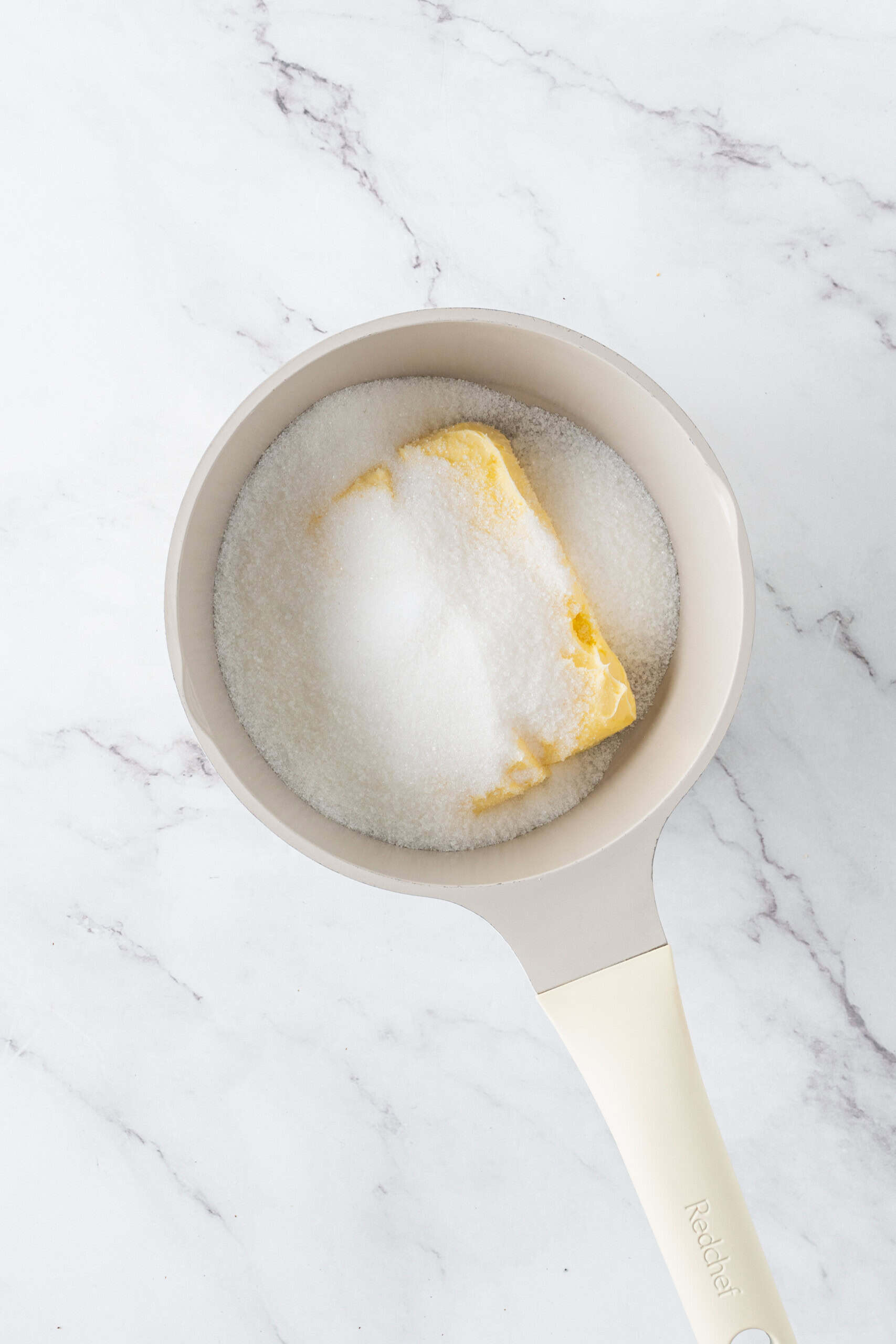 Butter and granulated sugar in a saucepan, ready to melt