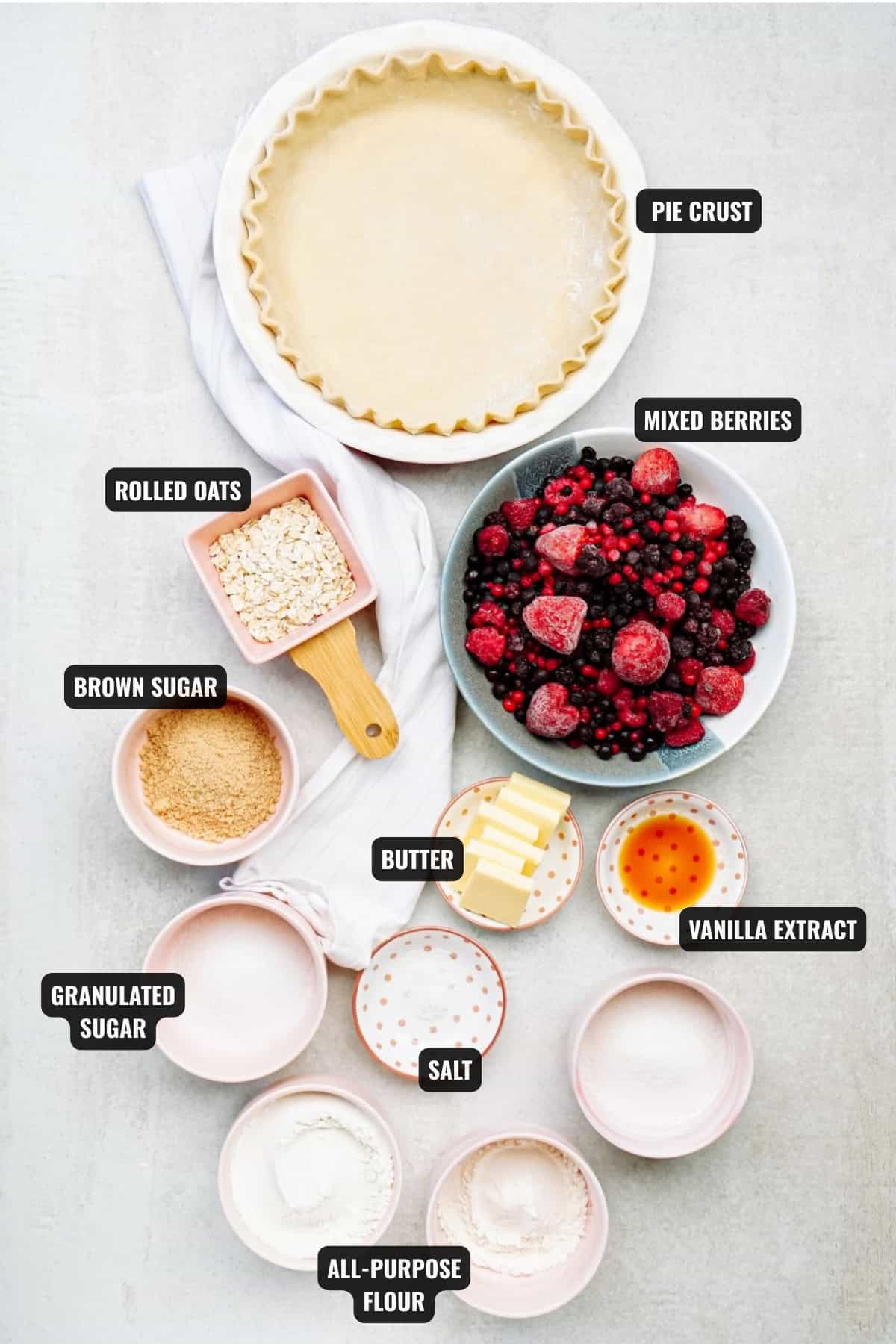 ingredients for mixed berry streusel pie recipe including pie crust, mixed berries, rolled oats, brown sugar, butter, vanilla extract, salt, granulated sugar, and all-puepose flour